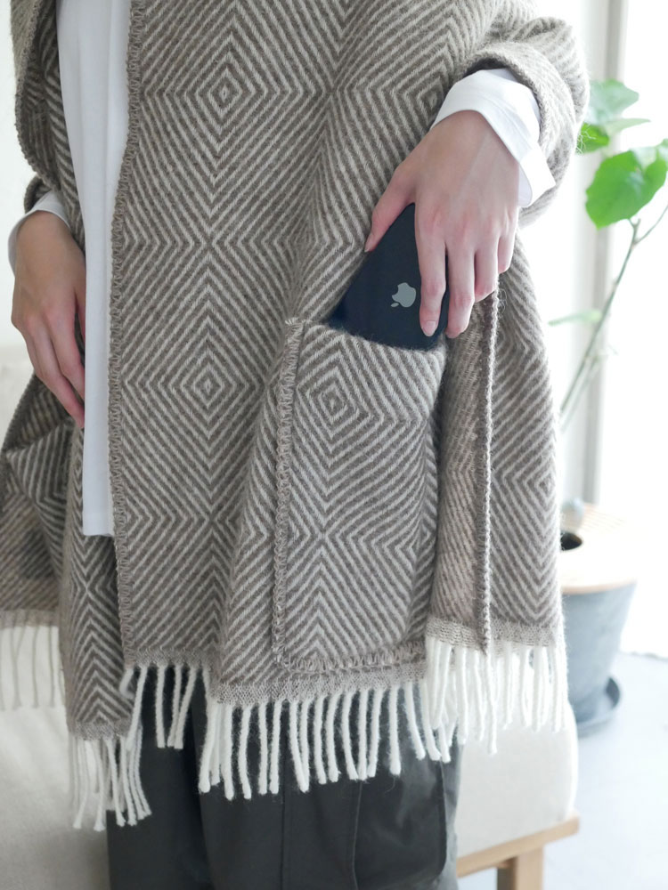 ラプアンカンクリのウールポケットショールMARIA、グレーと白の天然ウール素材で編み模様が施されたポケット付きショール