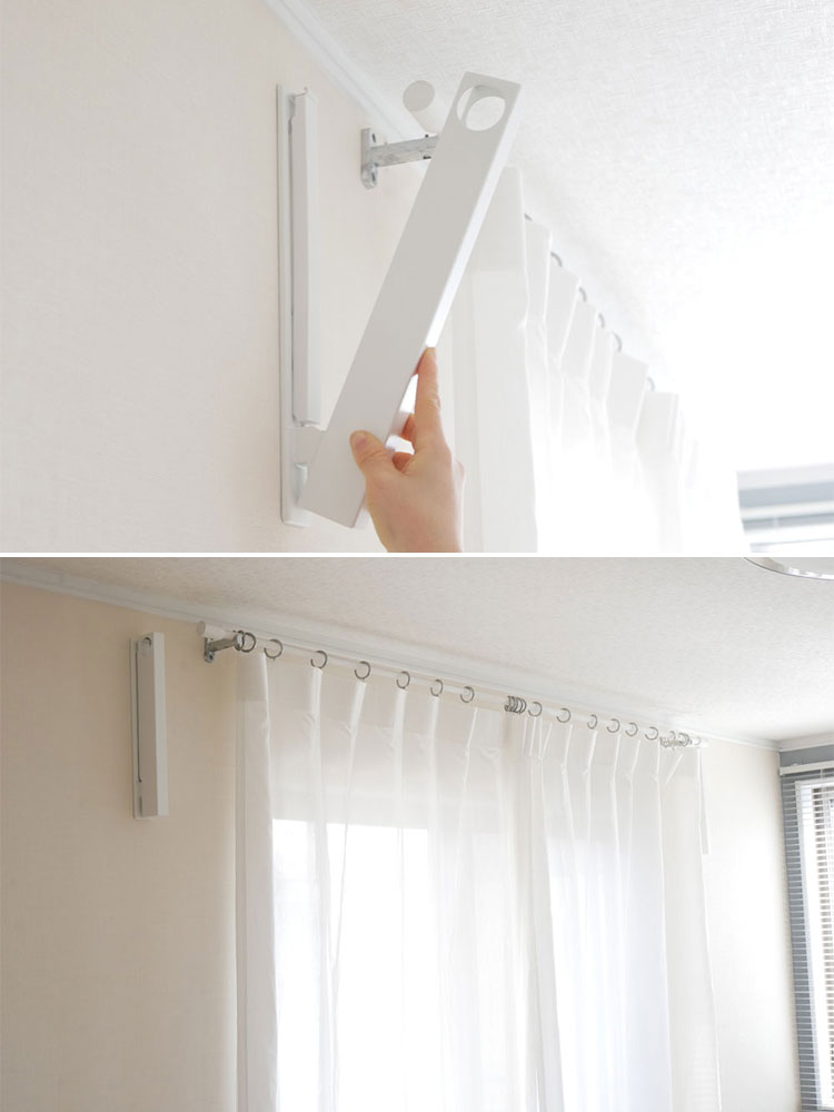 リビングの壁に設置されたウォール折り畳み物干し竿ホルダー