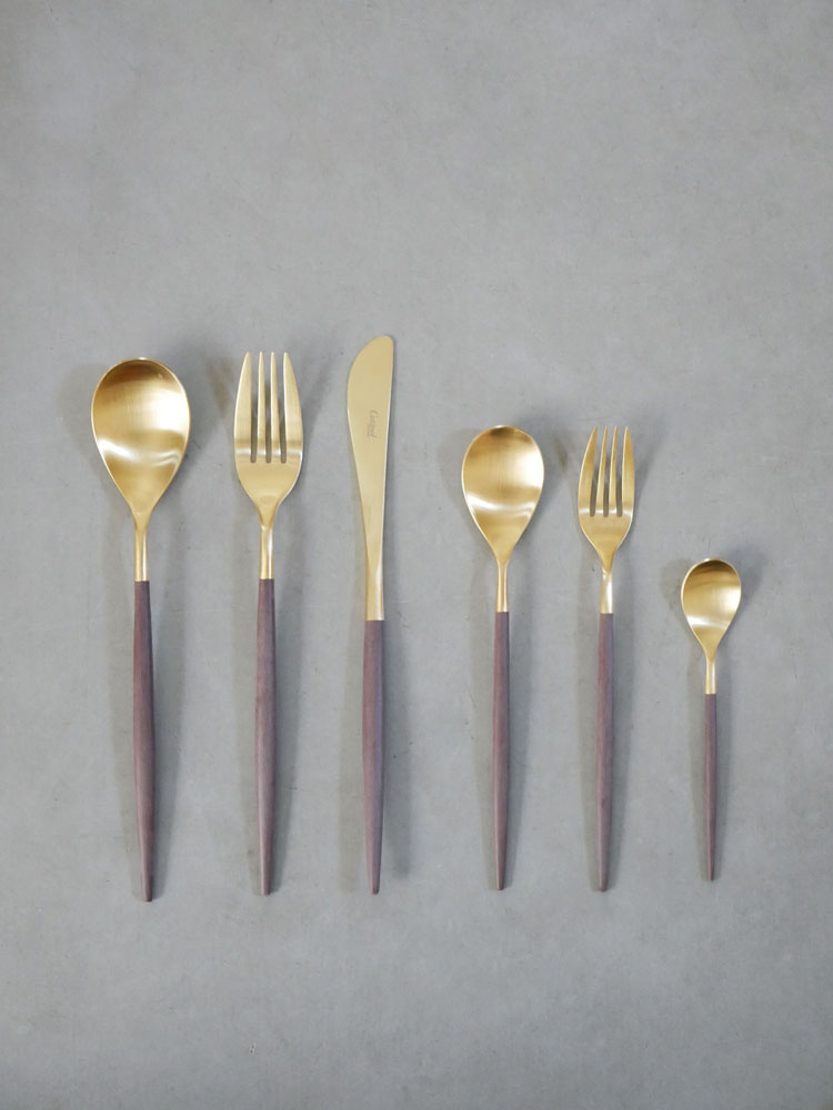 クチポールMIOカトラリーセットの写真。ブラウンゴールドとグレーシルバーのステンレス製フォーク、スプーン、ナイフが整然と並んでいる高品質な食器類。