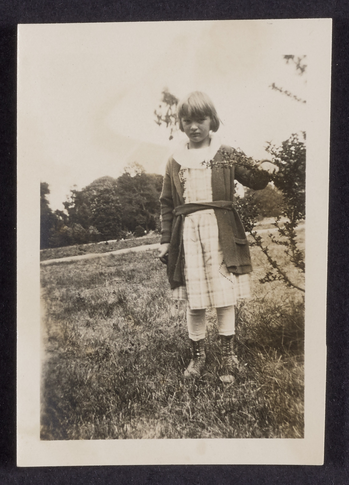 Sally Patterson visiting her mother's flower garden, 1918 (Internet Archive)