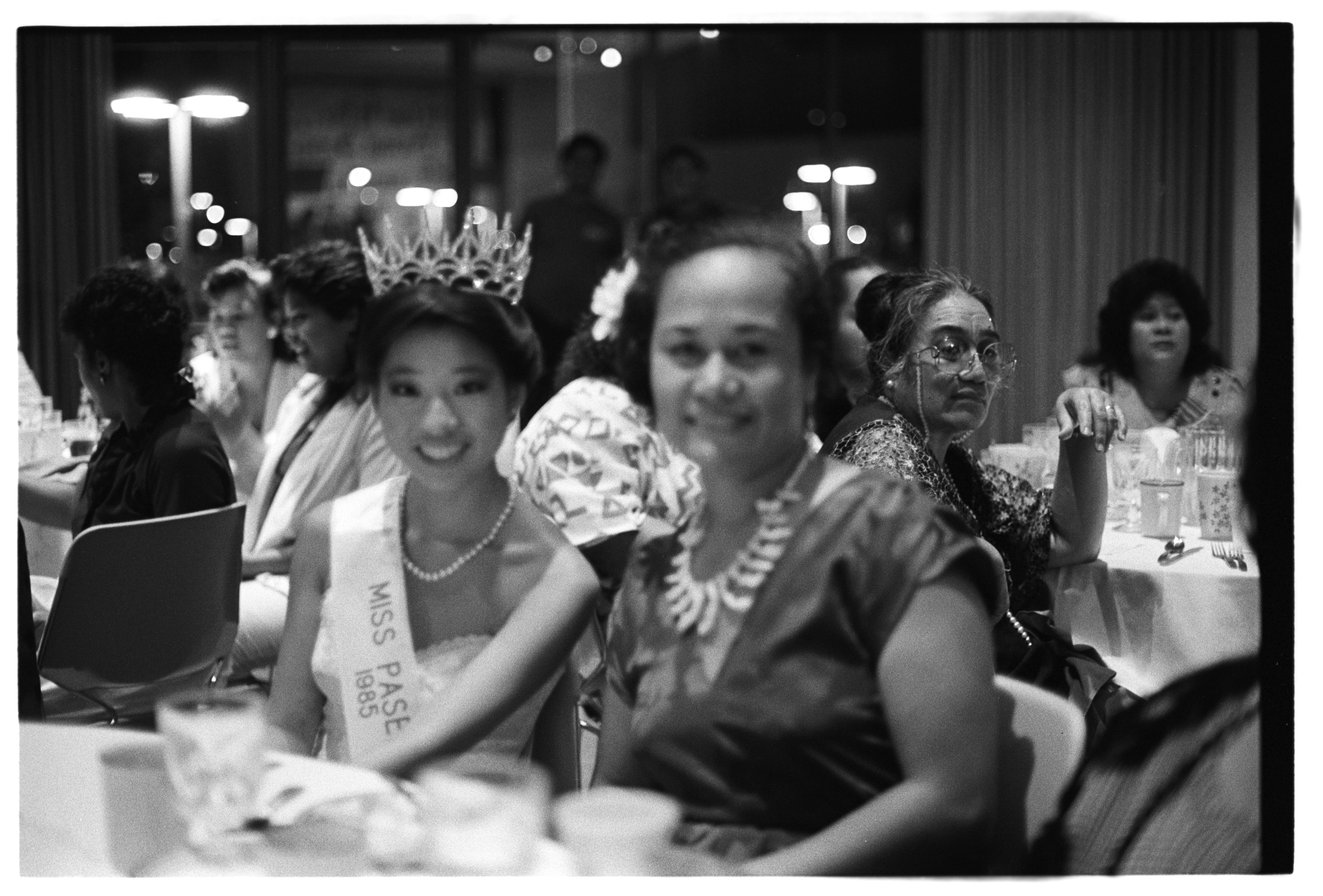 Young Person in Sash and Crown with Adult at Table, 1905 (Internet Archive)