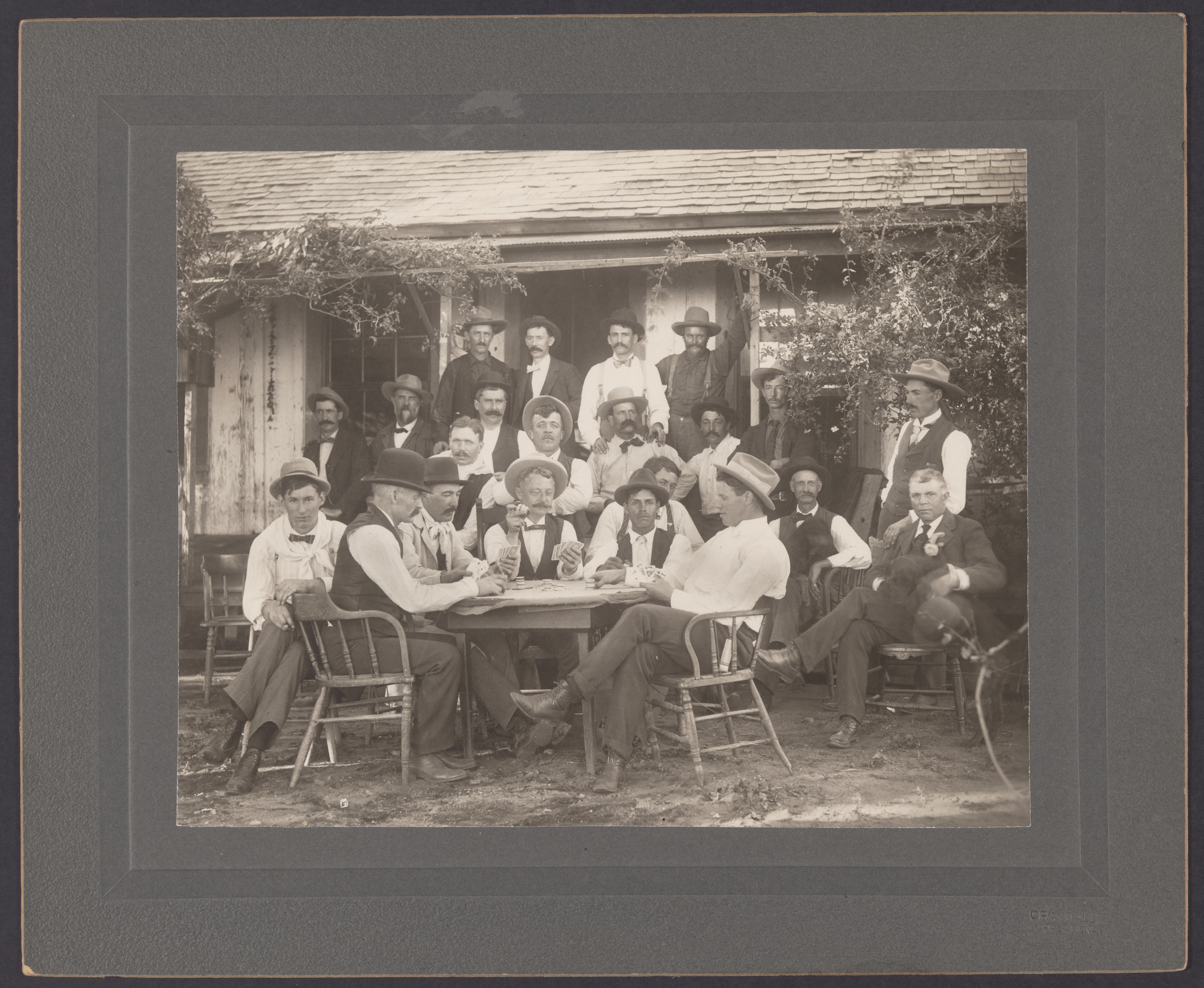 Group of men sitting in front of a building at Hall Ranch, 1900 (Internet Archive)