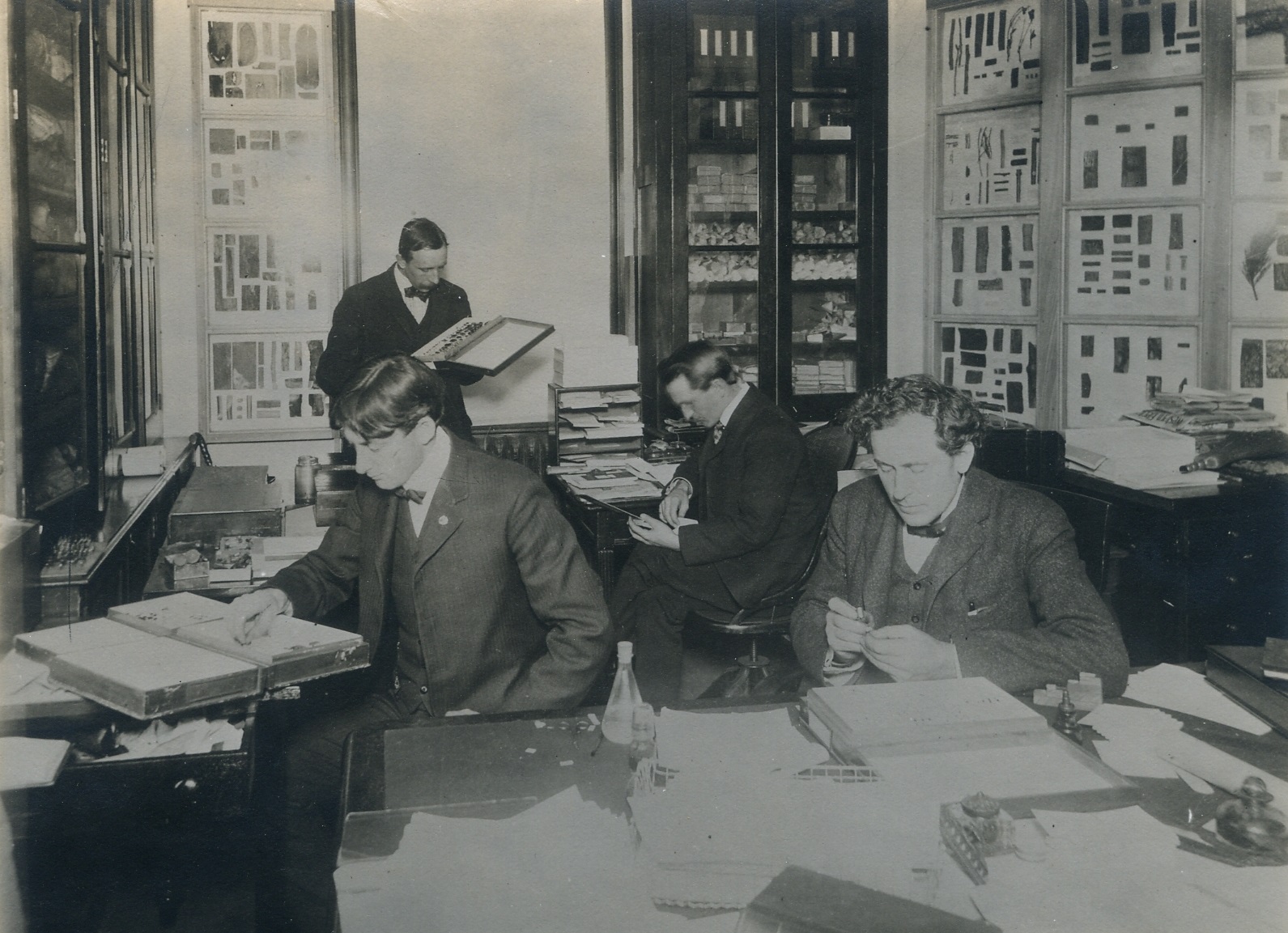 1902. Seated (L-R): H.E. Burke, Asst. Forest Expert; J.L. Webb, Asst. Forest Expert; and A.D. Hopkins, in charge of Forest Insect Investigations. Standing is F.C. Pratt. In the first forest entomology, 1902 (Internet Archive)