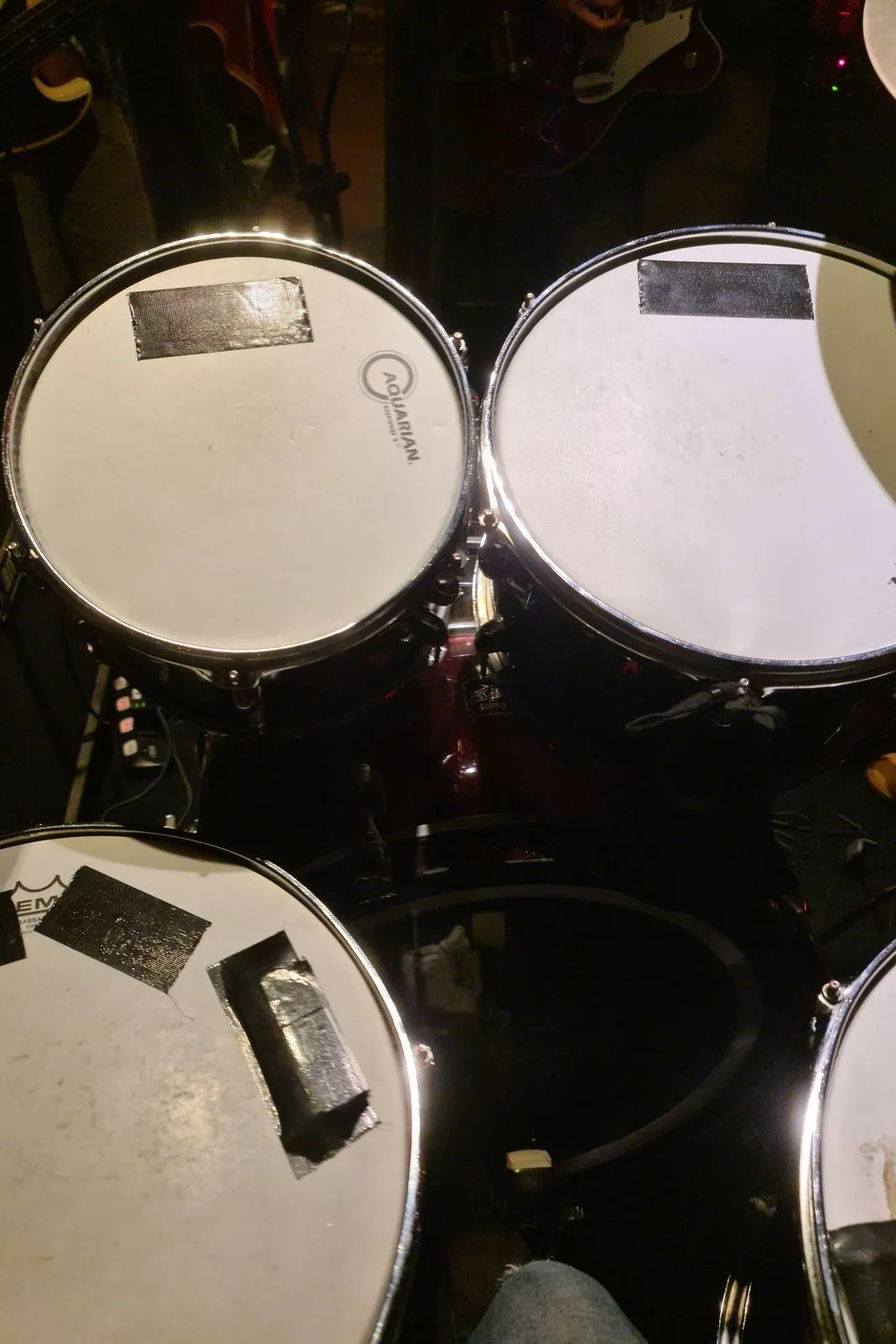 Close-up of drum kit toms and snare with duct-taped drumheads