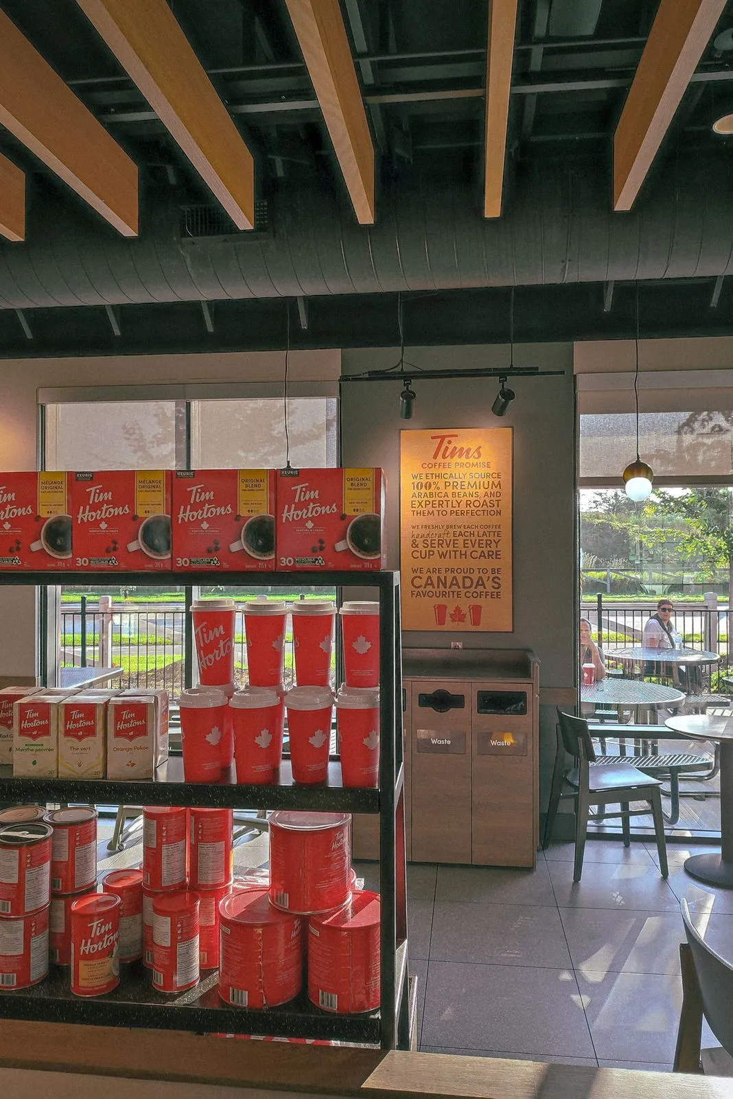 Interior of a Tim Hortons coffee shop with shelves of coffee and tea boxes