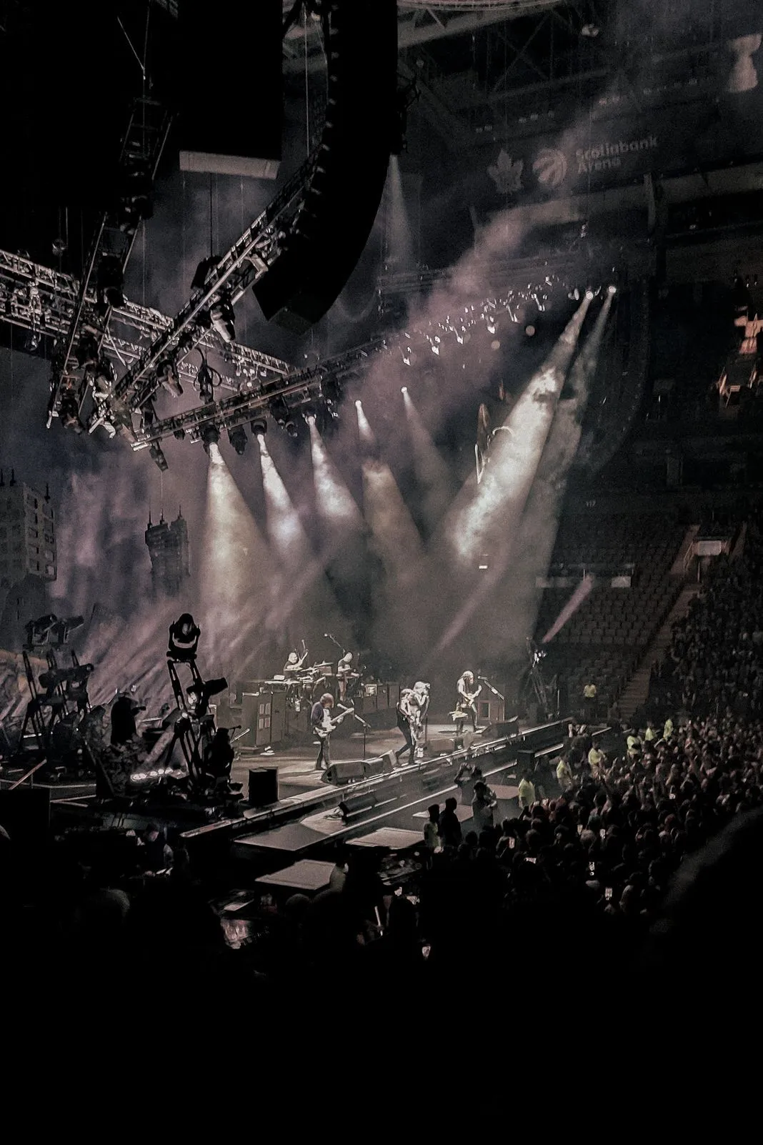 Concert crowd watching a band perform under stage lights at Scotiabank Arena