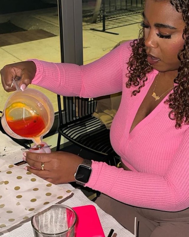Image of a woman pouring wax into a mold