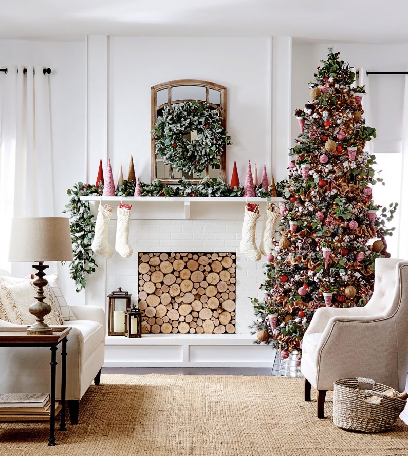 A cozy living room decorated for Christmas with a lit tree
