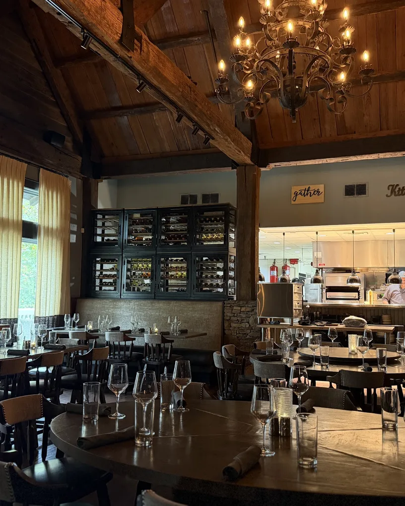 The chandelier-lit dining room and open kitchen at J. Michael's Prime in Canton, GA