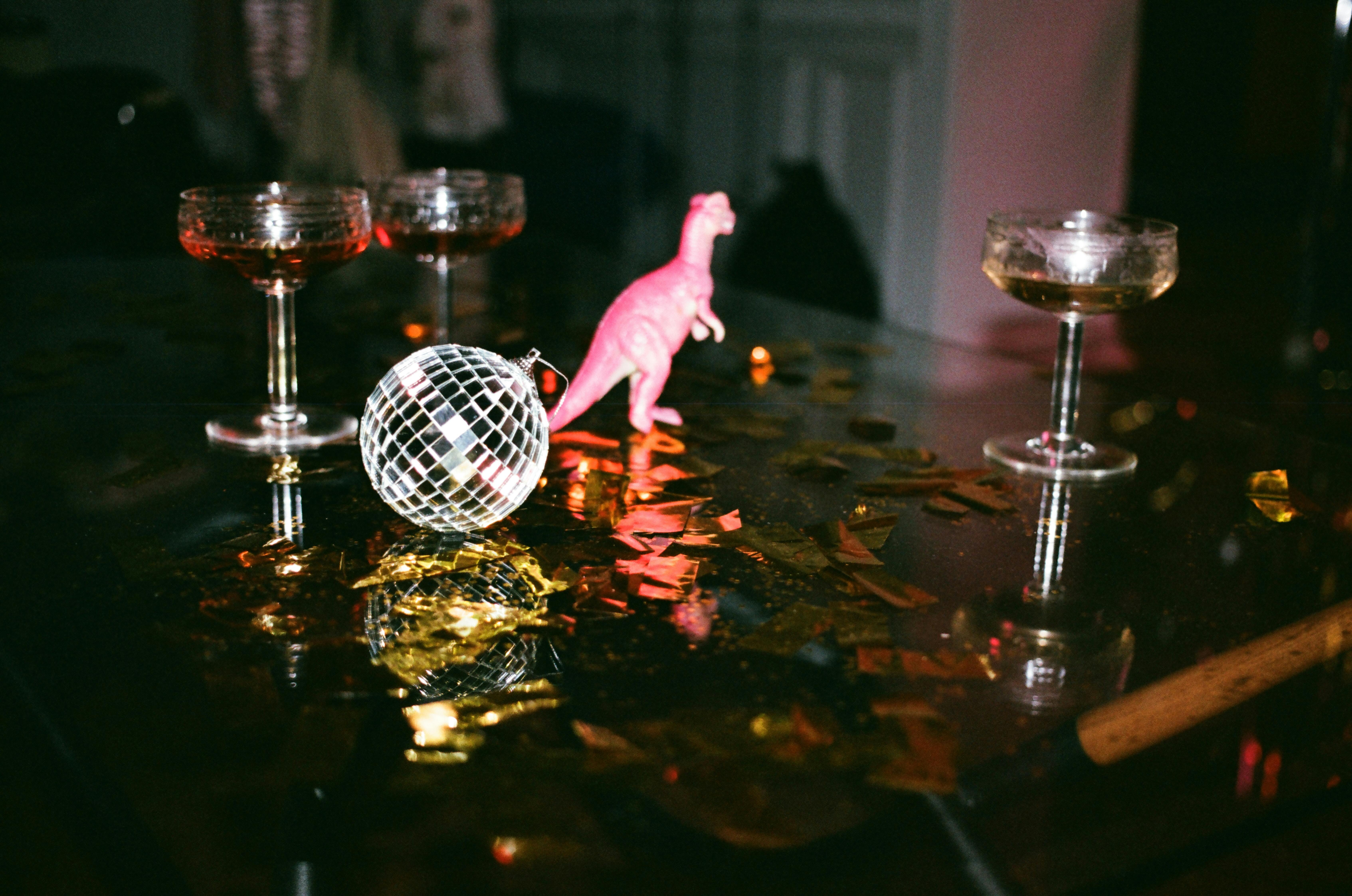round-gray-mirror-ball-beside-dinosaur-toy