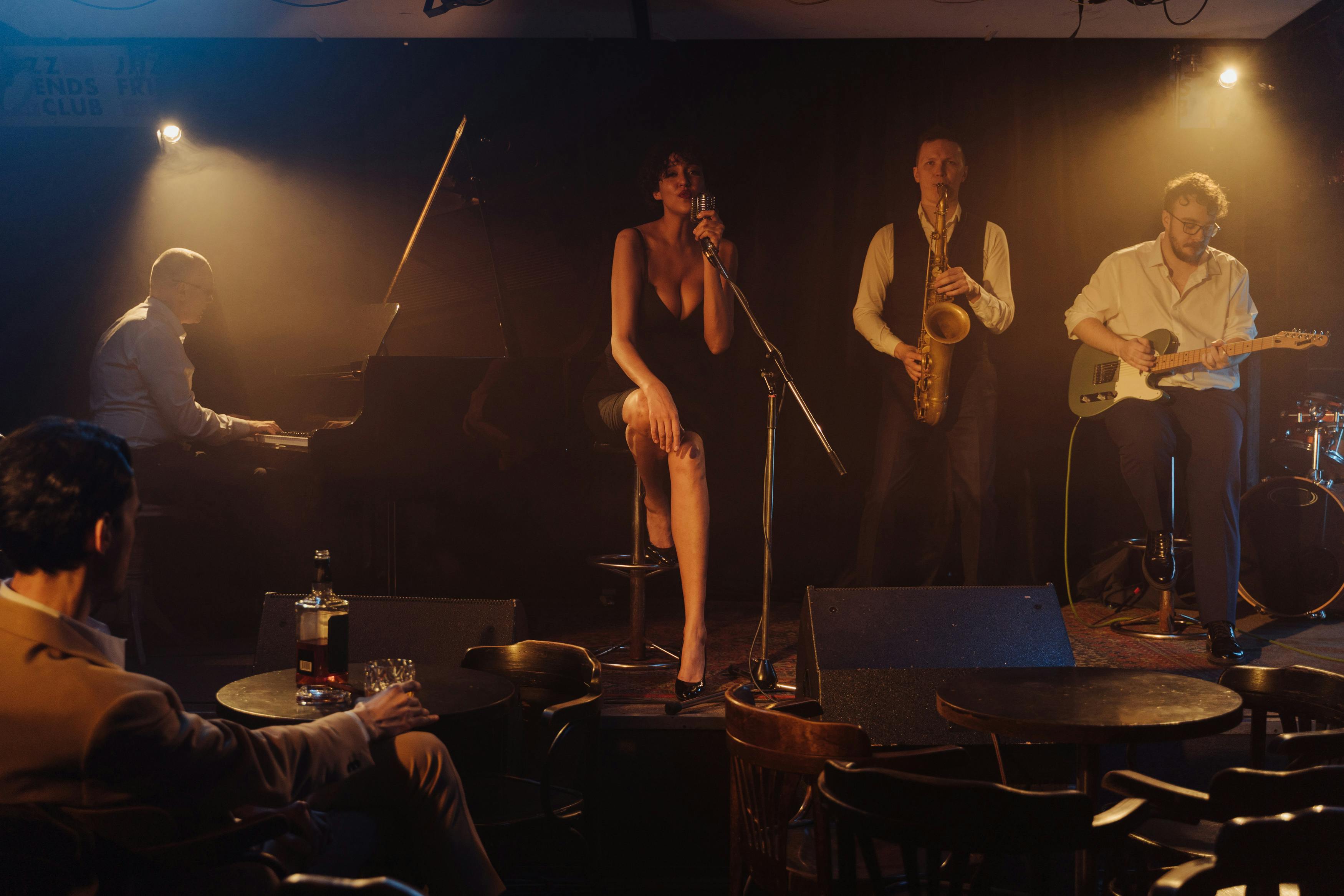 photo-of-a-woman-singing-near-musicians