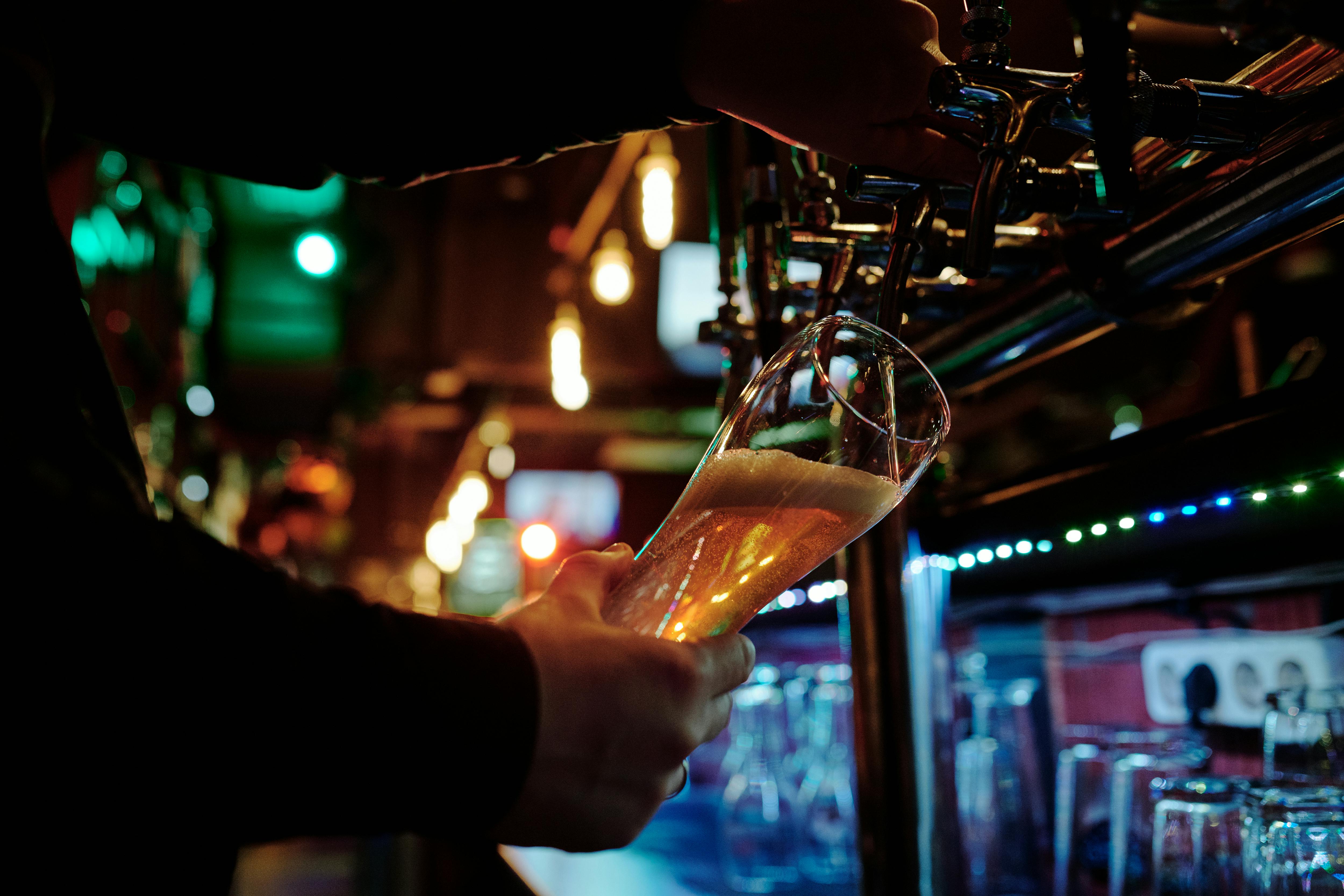 a-bartender-filling-a-glass-with-beer