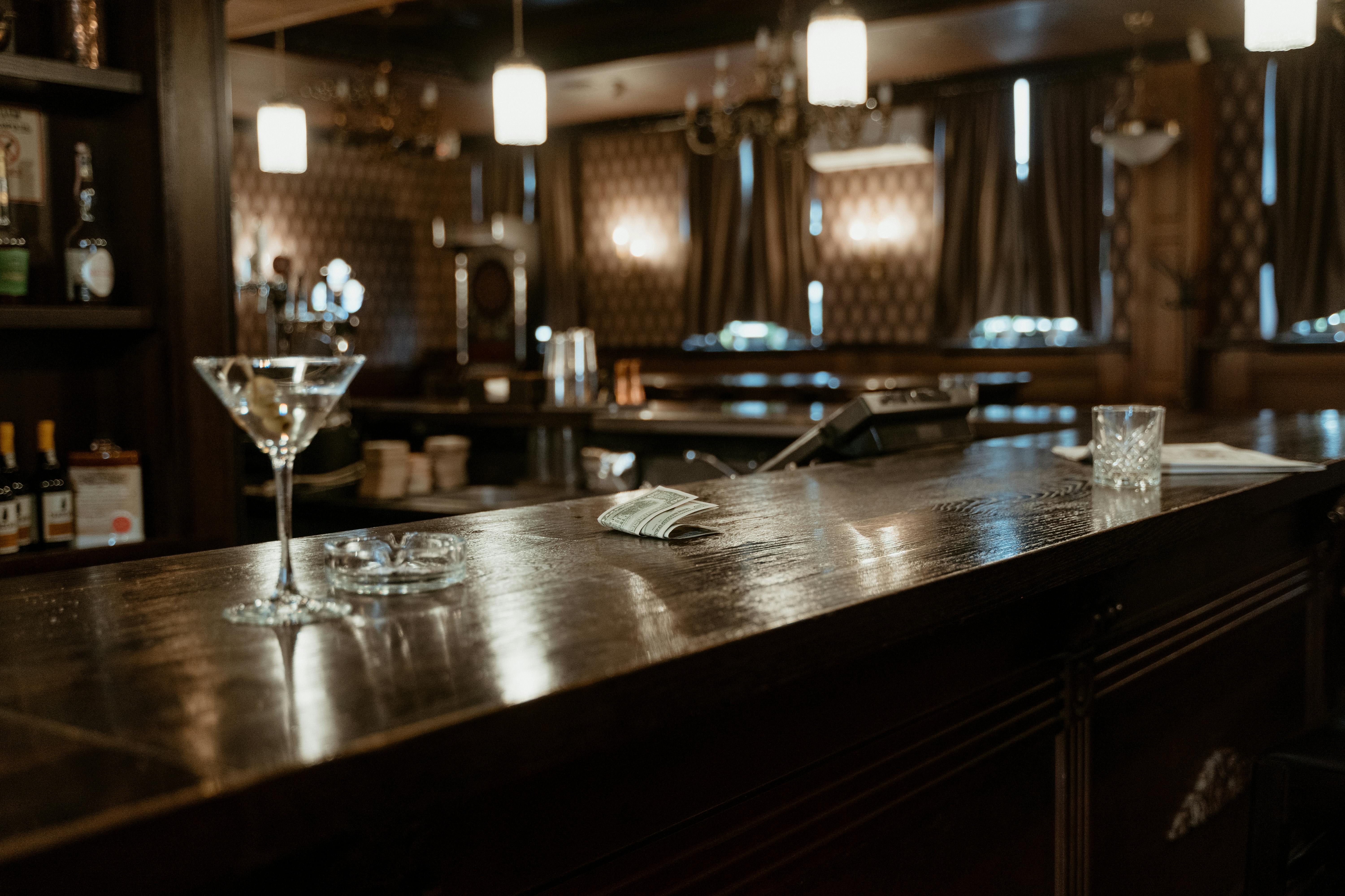 cocktail-glass-on-brown-bar-counter