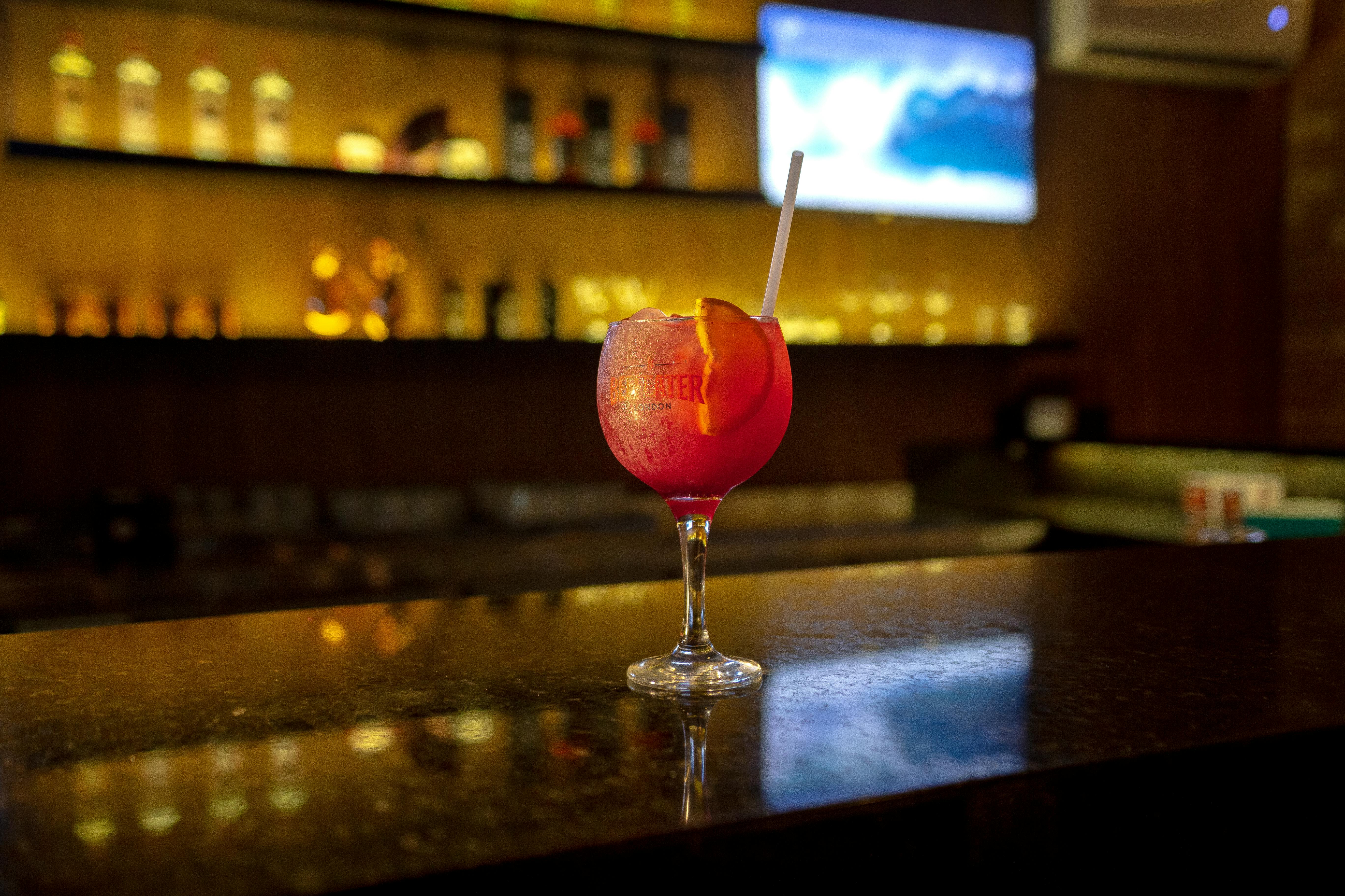 red-drink-in-clear-wine-glass-on-table