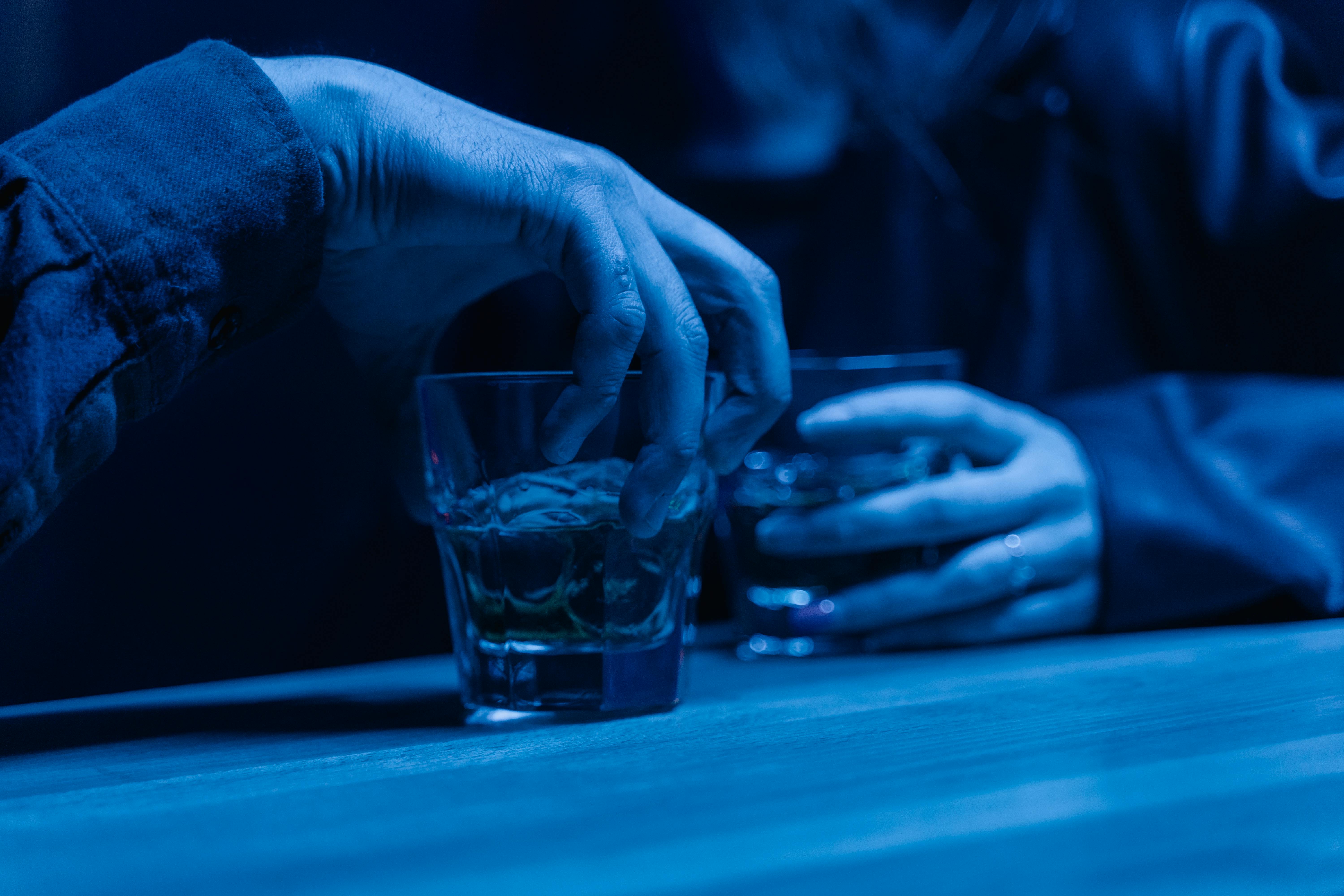 photo-of-a-person-s-hand-holding-an-alcoholic-drink