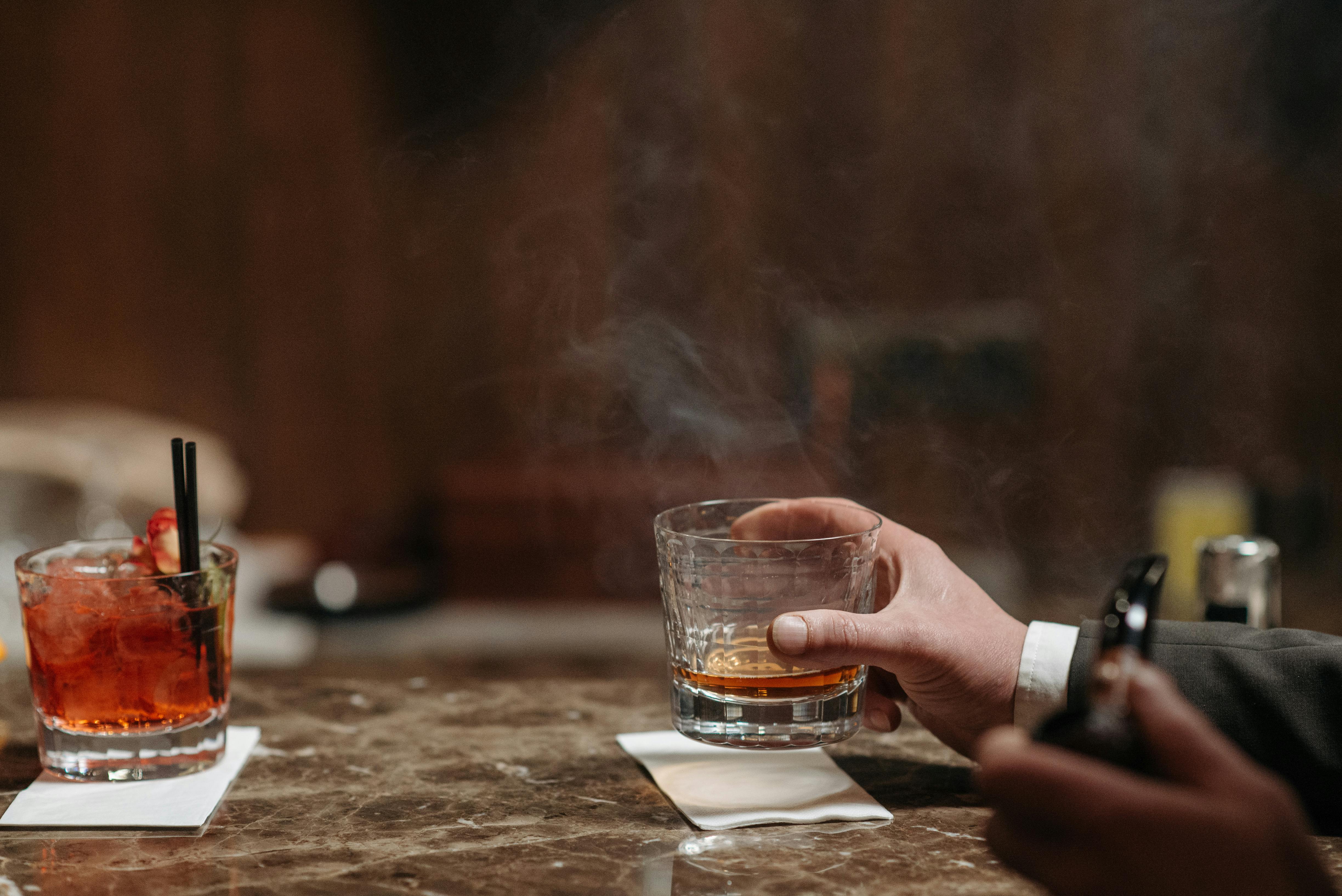 person-holding-a-glass-of-liquor