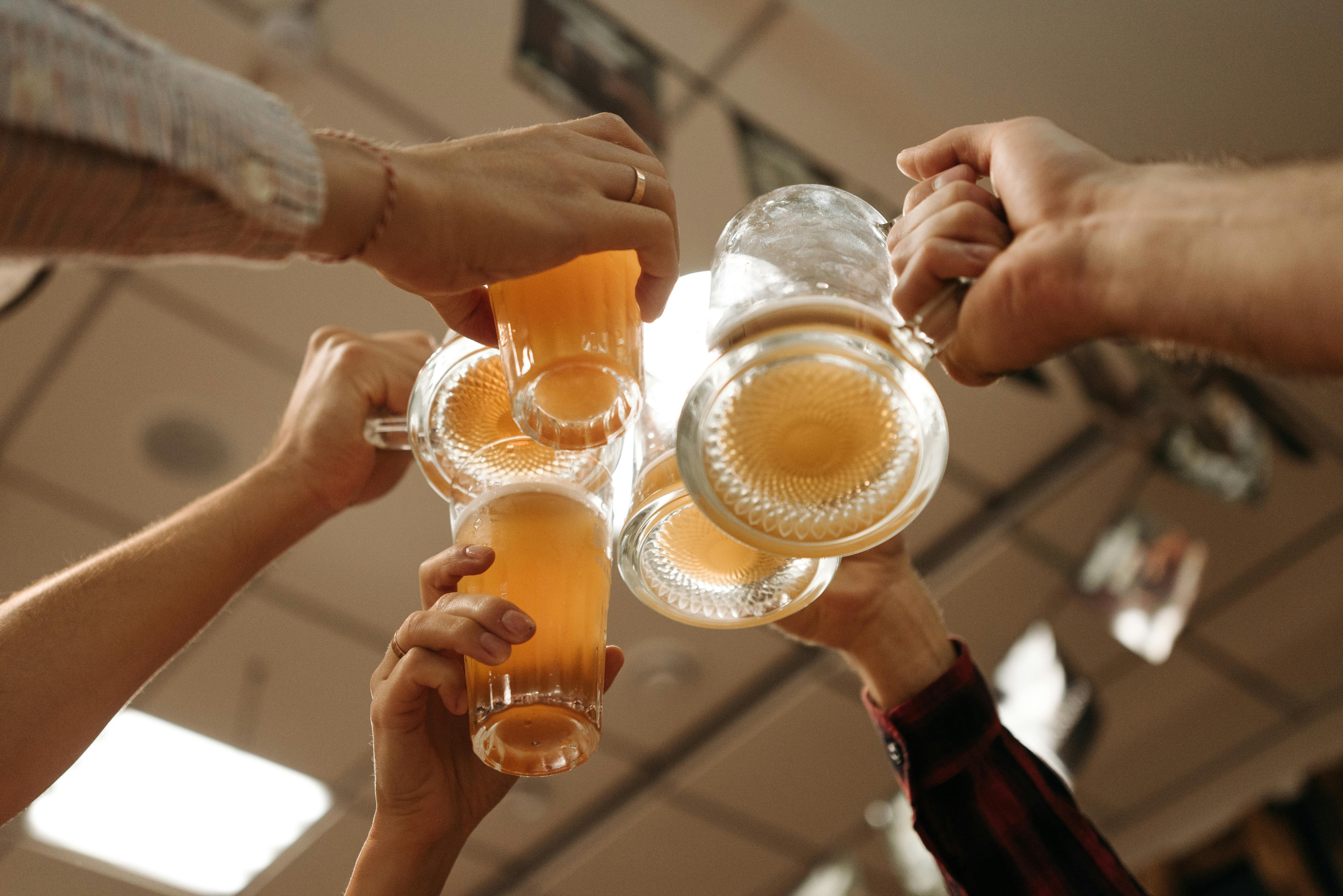 people-toasting-beer-glasses