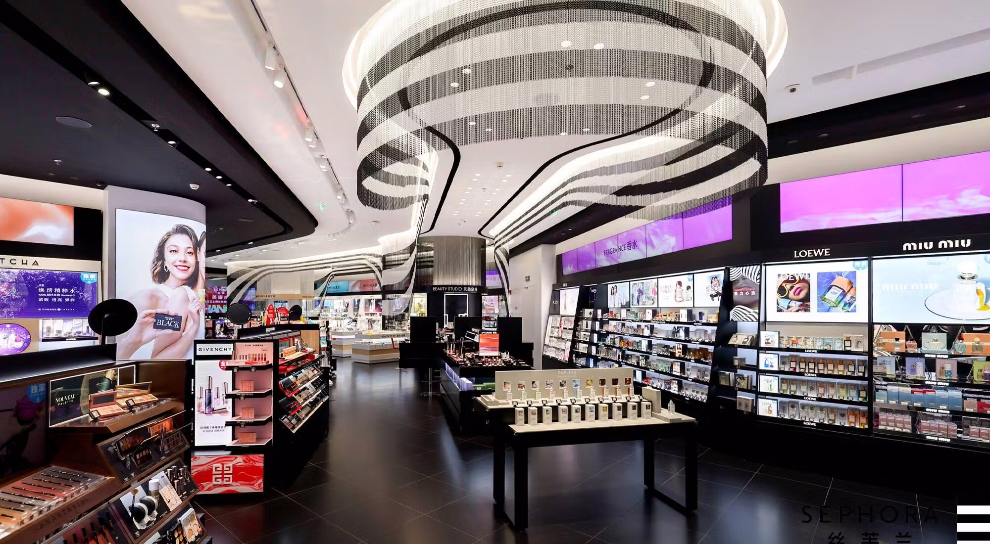 Sephora flagship store with sweeping ribbon-and-chandelier centerpiece