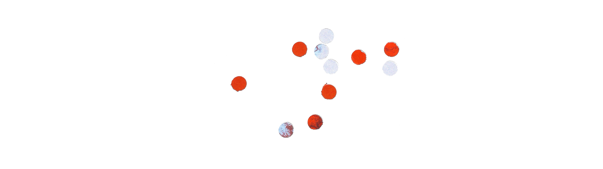 A series of small, scattered red and white circular dots placed on a white background. The dots are arranged in a seemingly random pattern, with varying shades of red and white, suggesting an abstract design or data visualization.