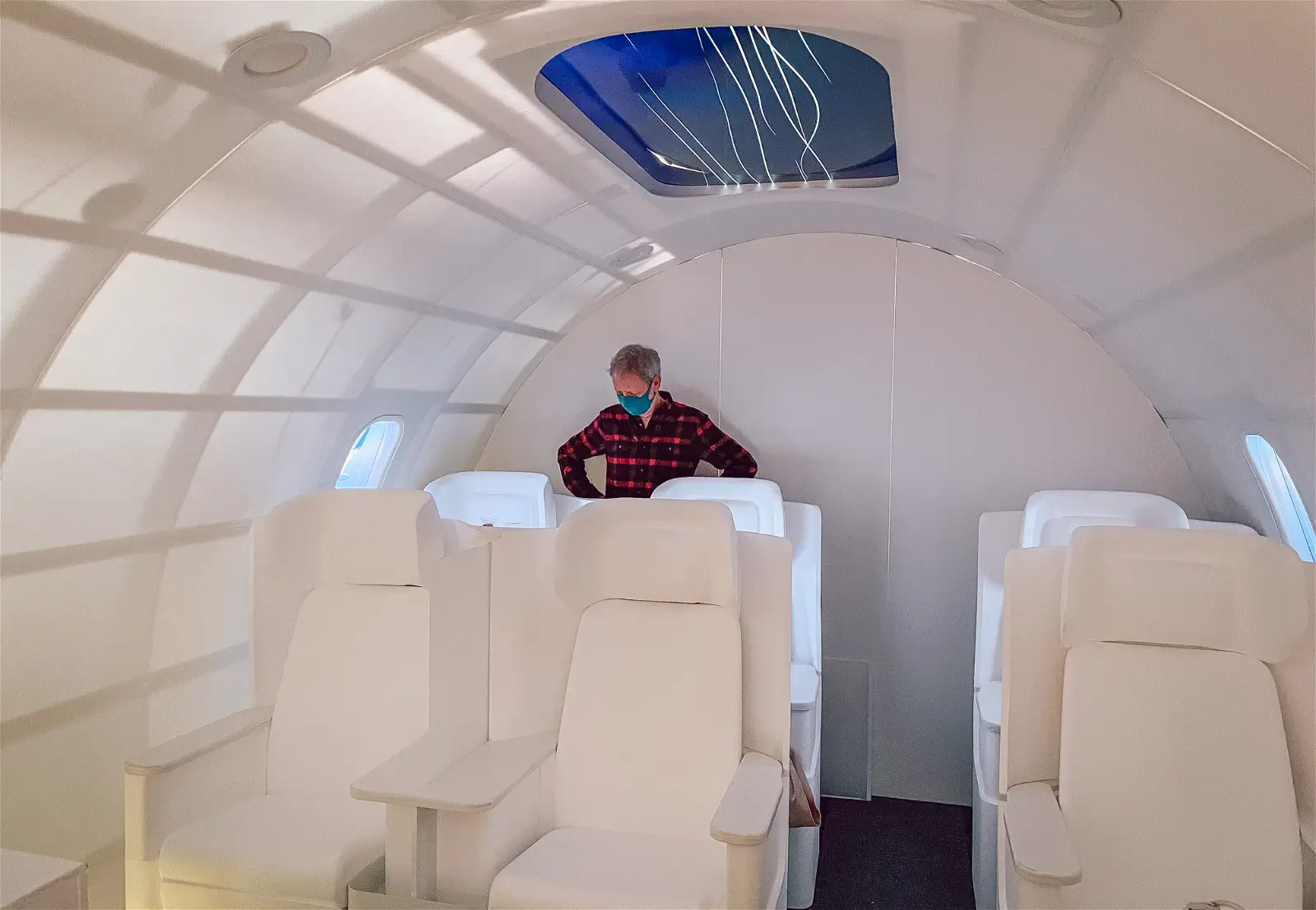 Thomas Overthun stanging inside a large full size prototype of the Boom Supersonic Jet