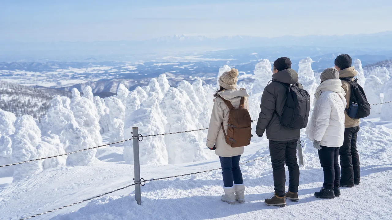 山形の樹氷を安全に楽しむ旅行者（横長・コピースペース）。山形旅行、樹氷、雪景色、東北旅行の記事や案内に使える商用素材です。