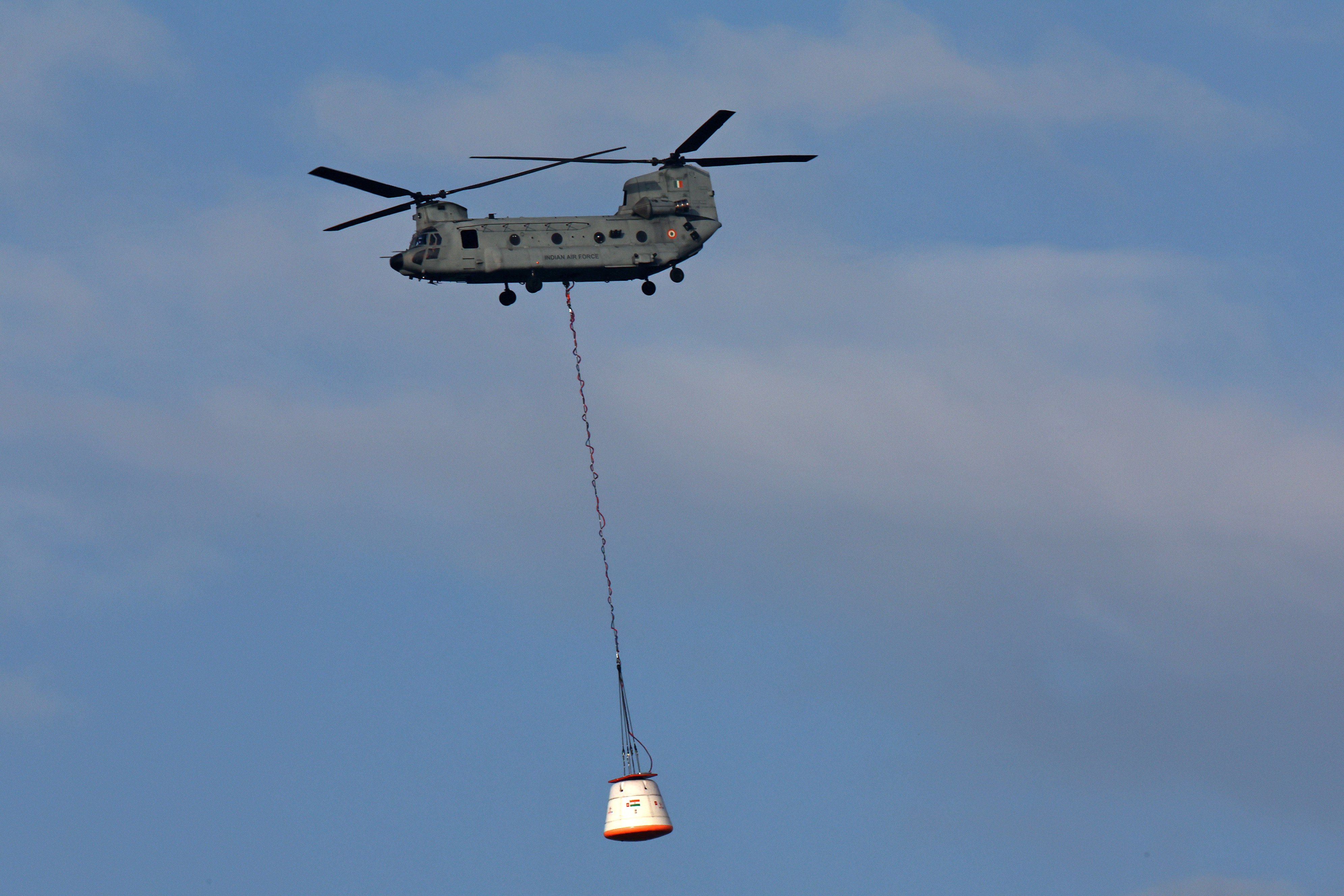 Crew module being lifted by an IAF Chinook to 3 km for release. Image Credit: IADT-01/ISRO