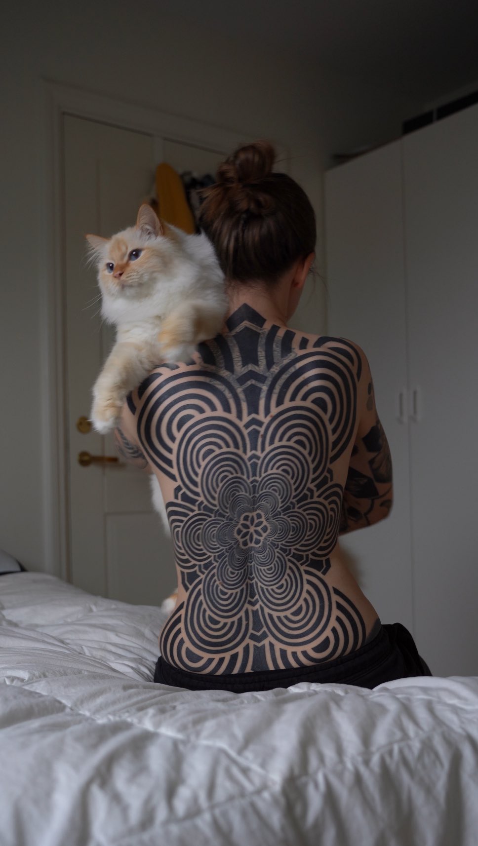 Fully healed back piece on my wifey  painting on the wall by my talented friend @mrhydetattoos #geometrictattoos #geometrip #mandalatattoos #blacktatt