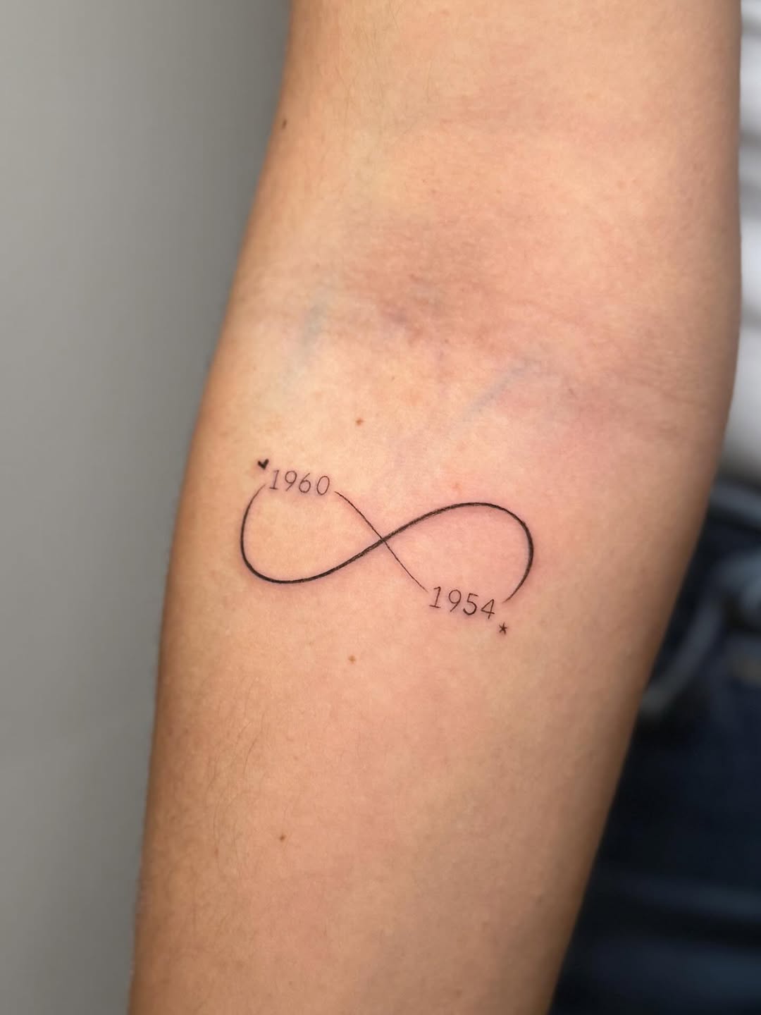 The original design evolved into an infinity symbol with her parents’ birth years.
So fine, subtle, and full of meaning, the perfect piece for her. 
A