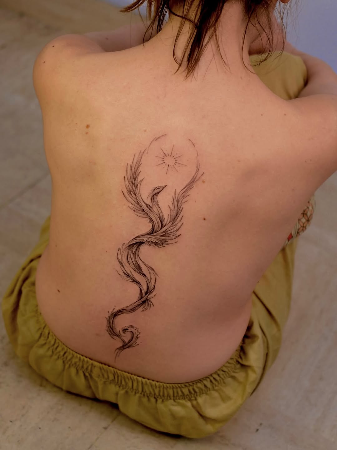 Not from flame does the phoenix rise, but from obscure waters, ascending along the spine, carrying what it kept in shadow, until, in the sun, it holds