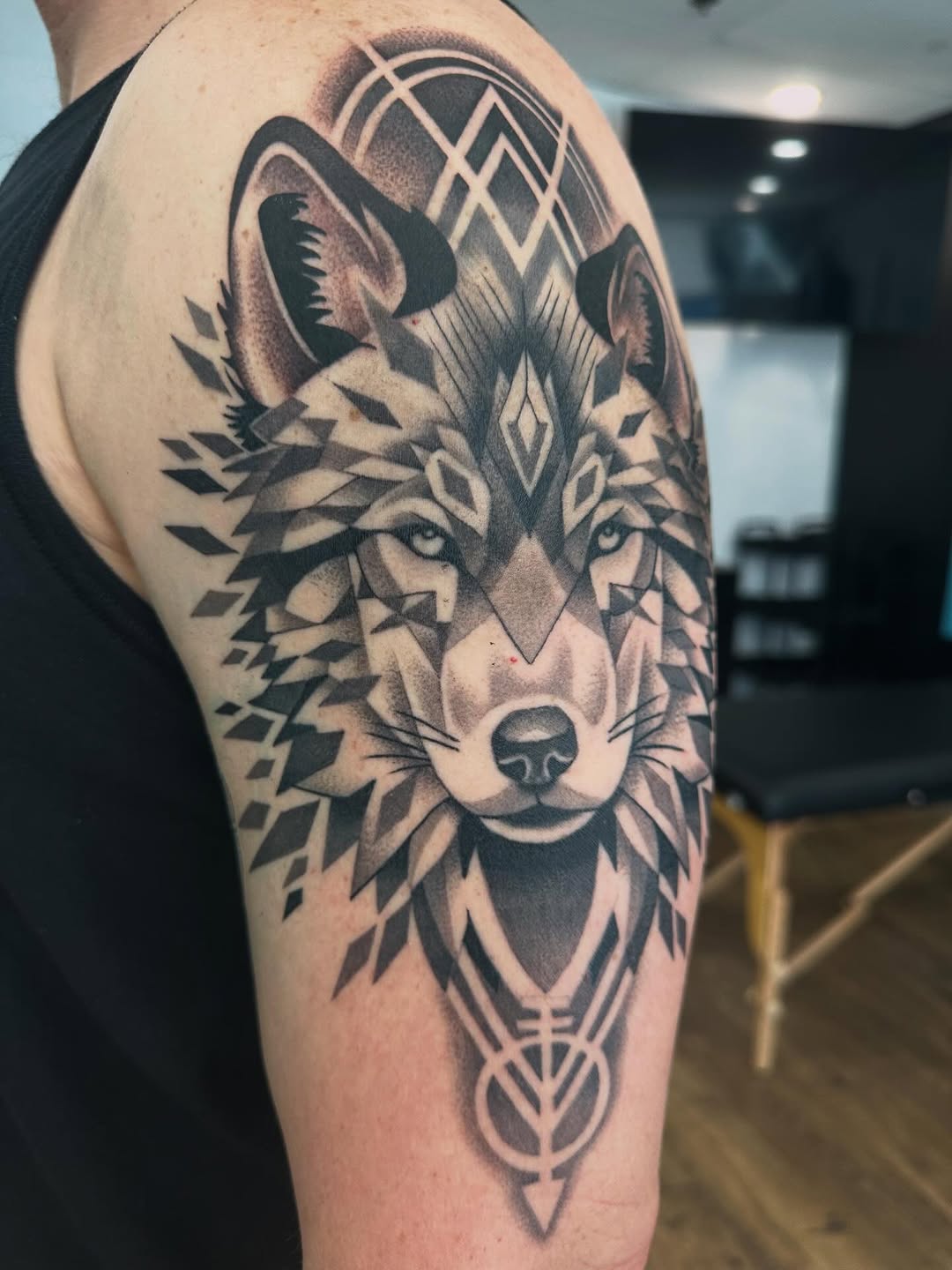 Precision meets instinct. 
Geometric wolf piece with layered dotwork and bold contrast—built to flow with the shoulder and stand strong from every ang