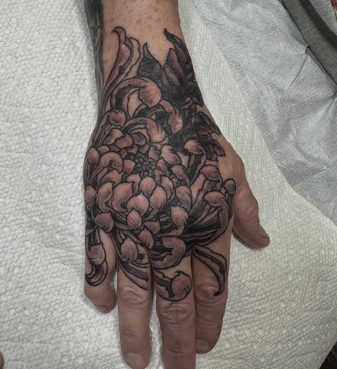 Chrysanthemum hand tattoo by @jeff_johnson_tattoo