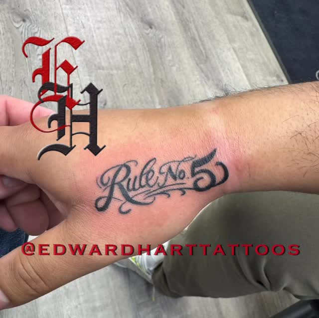 Fun little lettering hand jammer done today by @edwardharttattoos at @mainstreettattoonj. Solid black “Rule no. 5”. with flourishes.  Kept it solid be