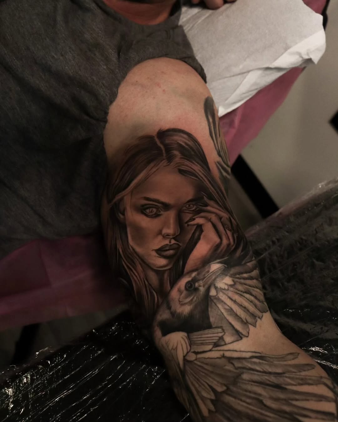 A woman sat alone in the forest, tracing the scars on her arms as a black crow landed beside her. It tilted its head, watching her with eyes that glea