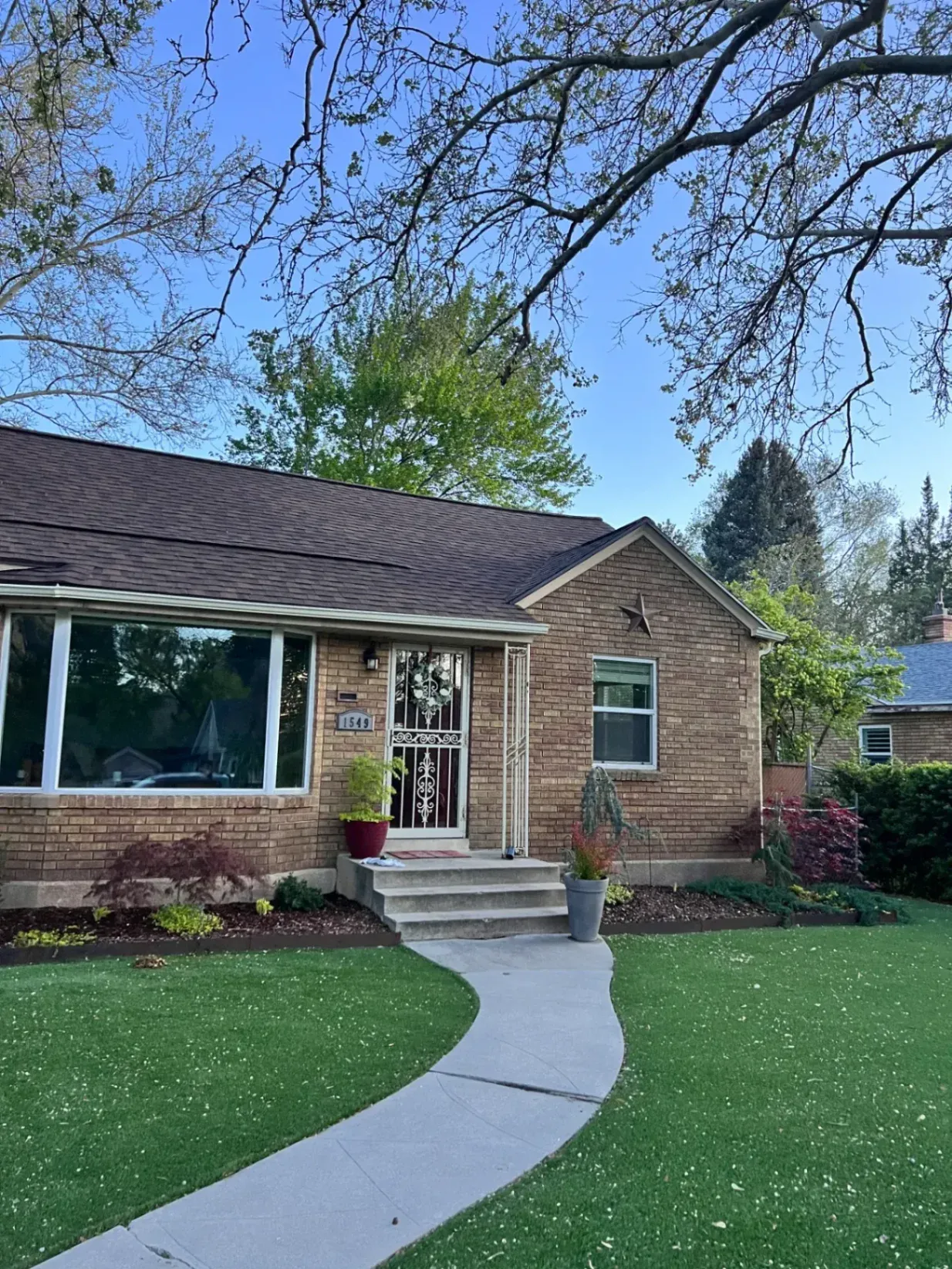 New dark brown asphalt shingle roof installed on a single-family home in South Ogden, UT by North Point Roofing LLC.