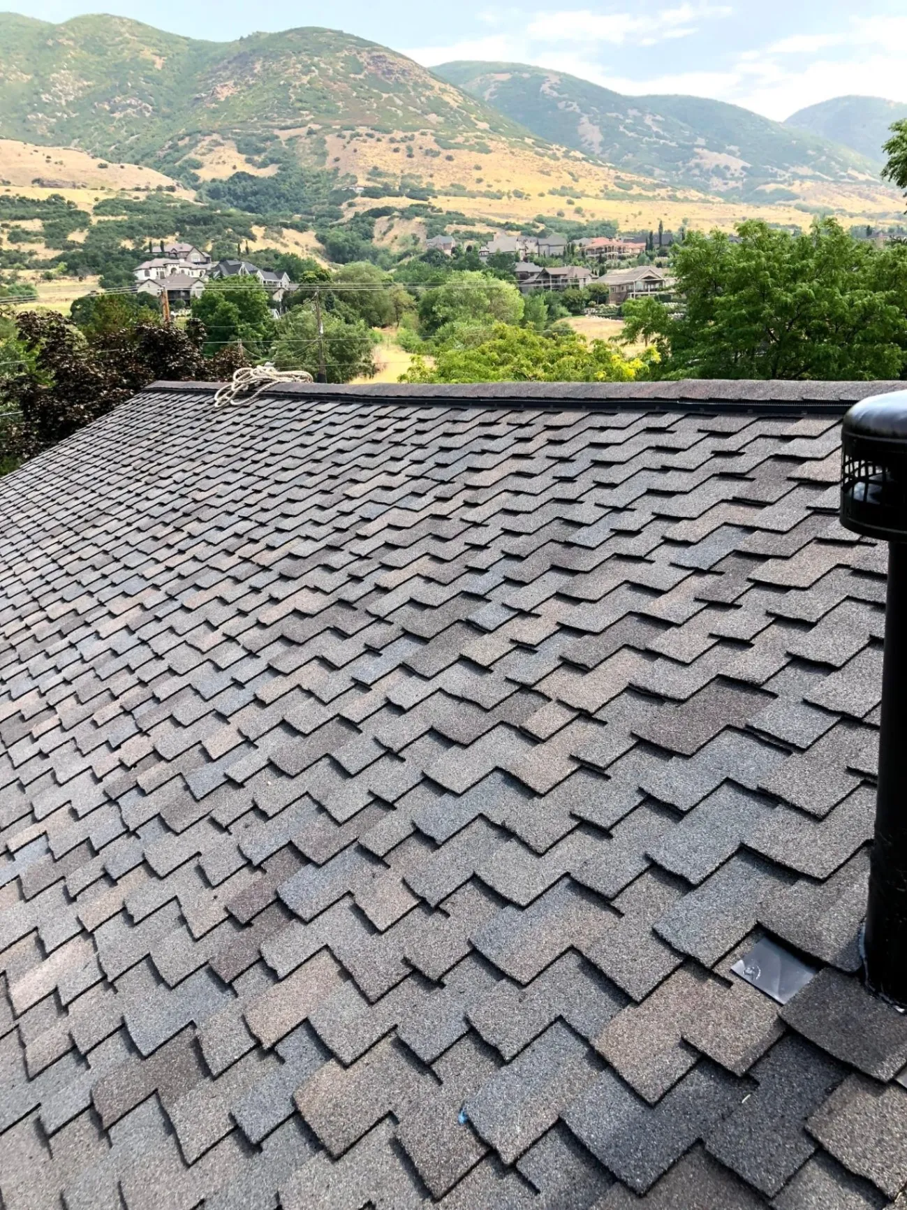 Roof repair project featuring dark architectural shingles and pipe boot sealing in South Ogden, UT, by North Point Roofing LLC.