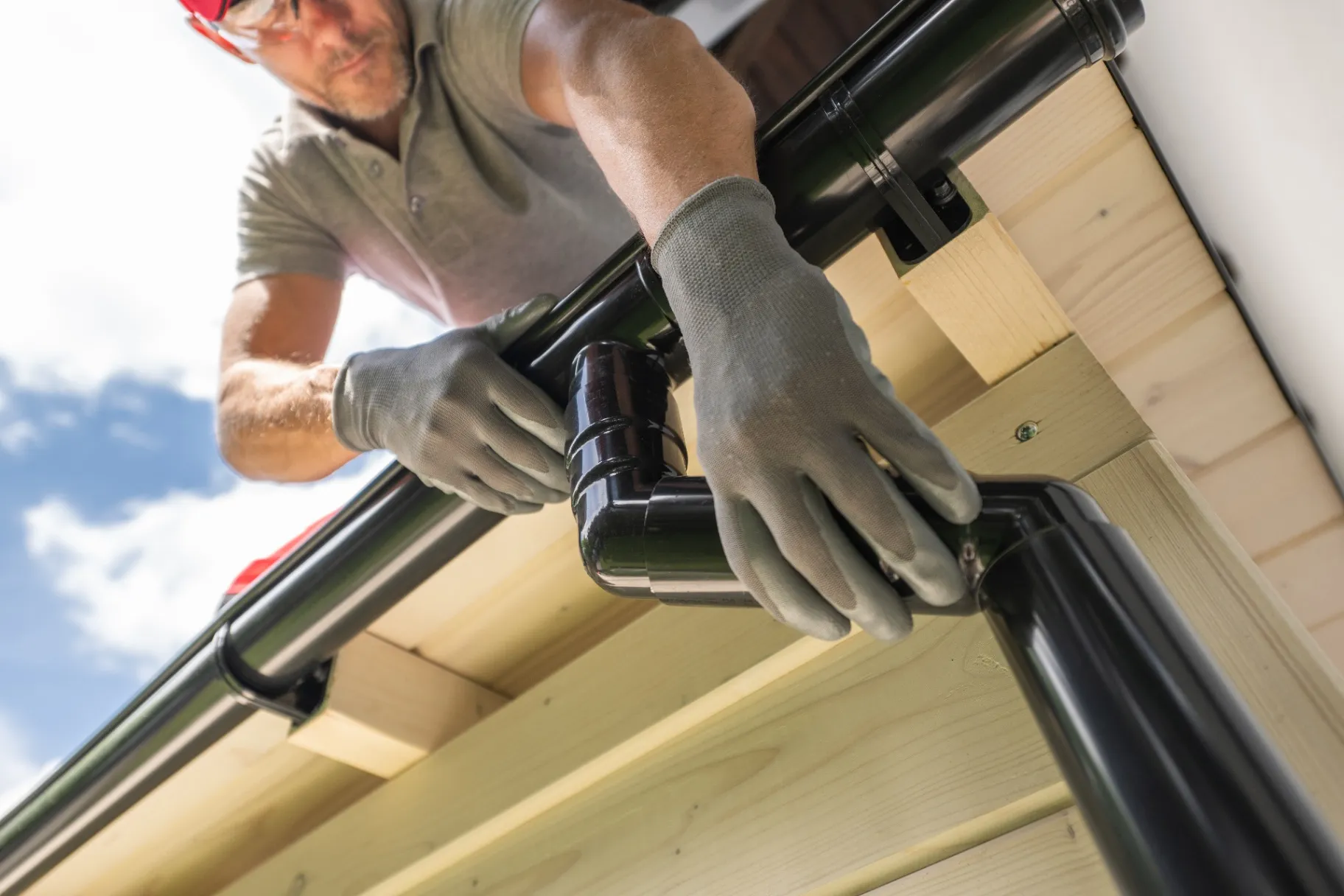 A worker installing a gutter system