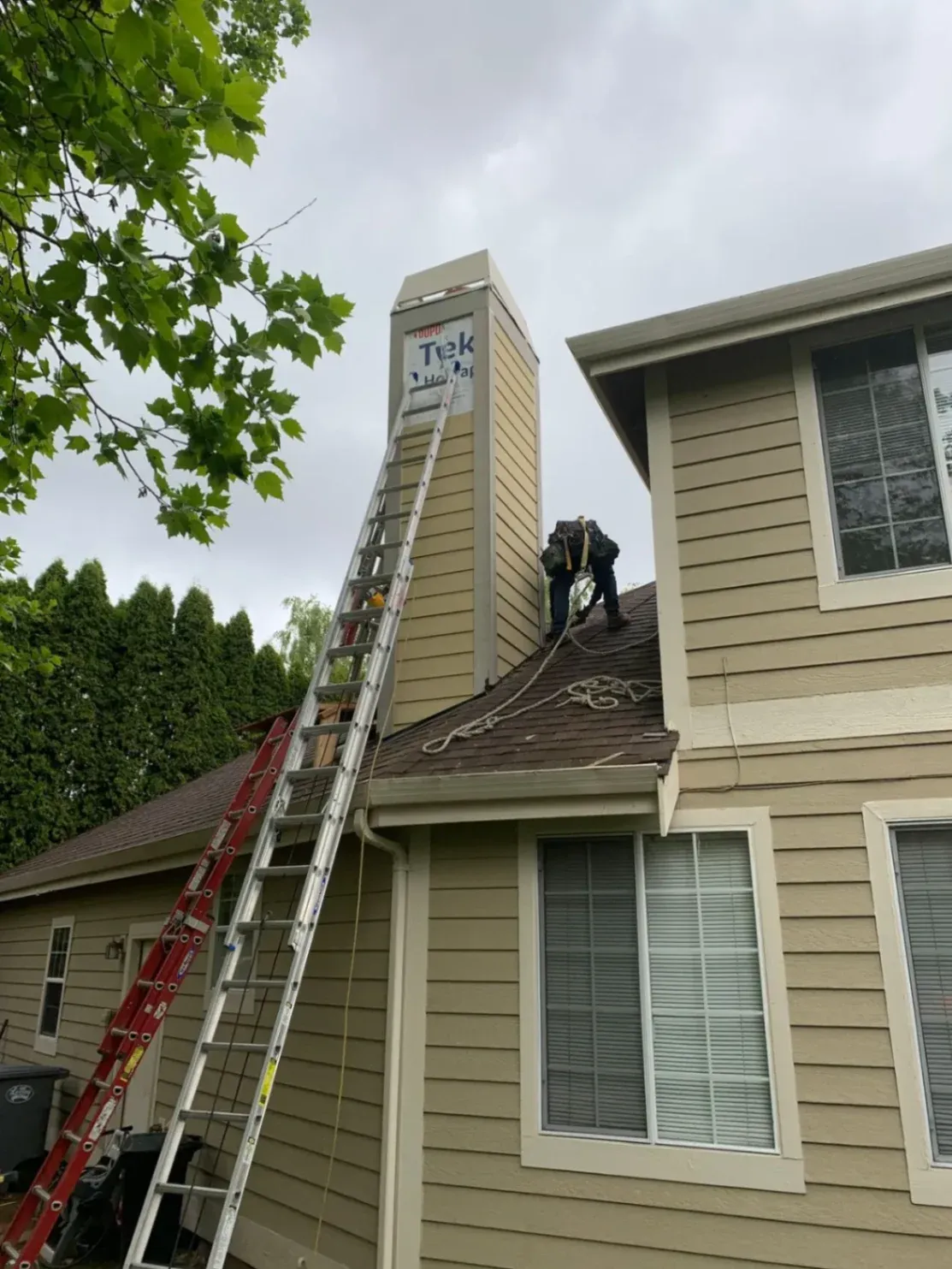 A local siding contractor in Mercer Island, WA, carefully sealing and repairing damaged wood framing to ensure a leak-proof home exterior before final plank installation.