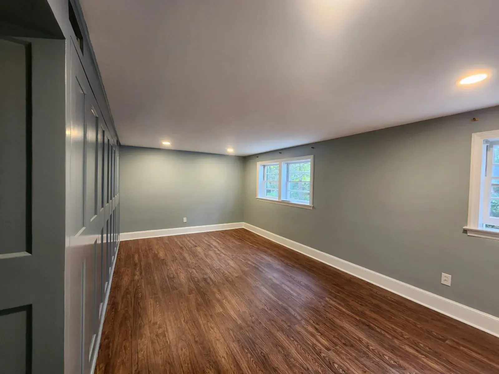 Freshly painted interior room with soft blue-gray walls, white trim, and recessed lighting, showcasing a recent interior painting in West Columbia with clean lines and a polished finish.