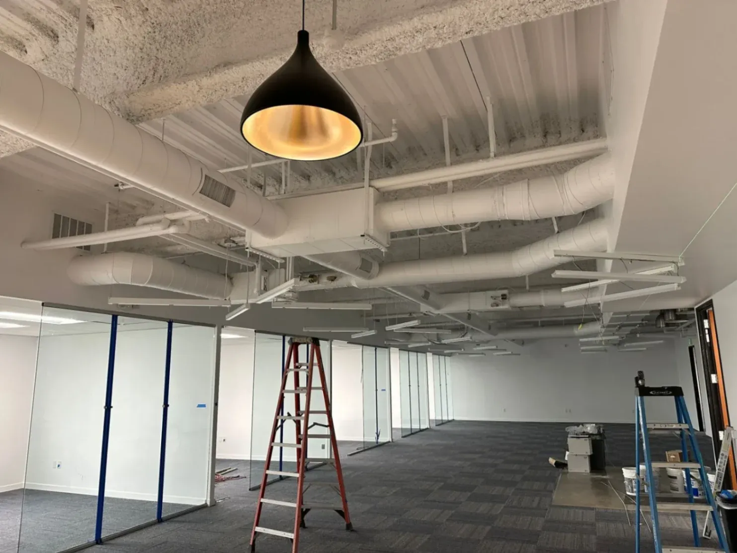 Finished commercial HVAC ductwork in a modern office space in Costa Mesa.