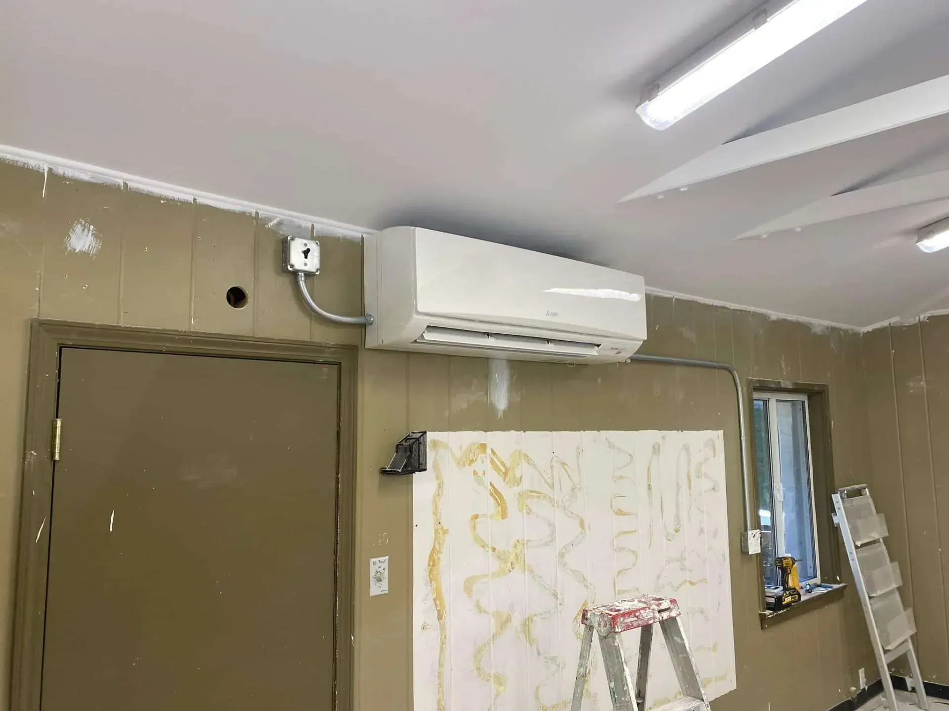 Wall-mounted mini split AC installed in a room during renovation in Costa Mesa.