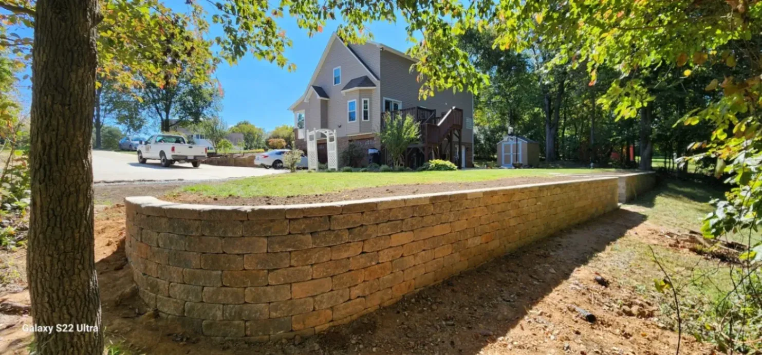 Conquer Slopes and Erosion with Our Custom Retaining Walls in Stone, Brick, or Concrete
