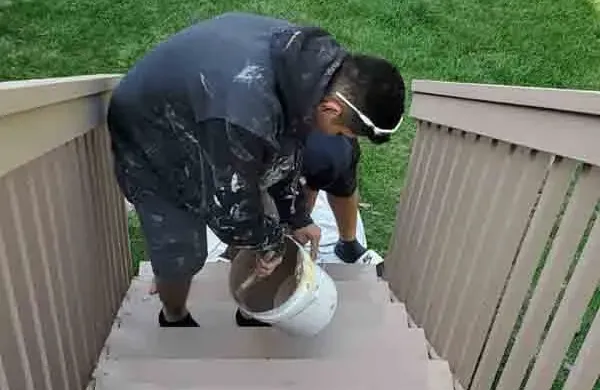 A professional painter applying stain - Deck Staining Near Eagan, MN