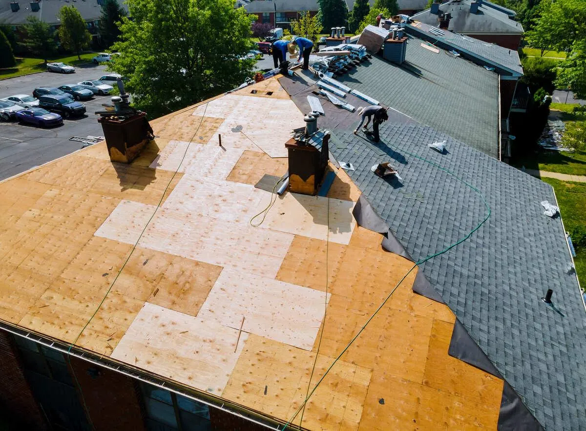 A team of roofers working hard under the sun