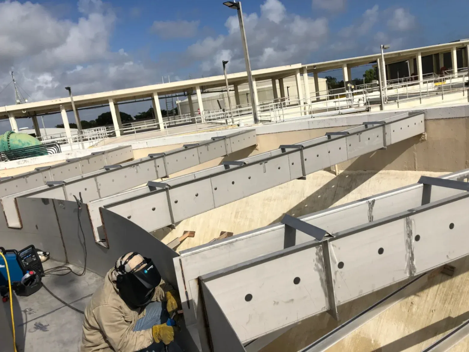 Precise custom metal fabrication in West Palm Beach, FL, featuring a certified welder constructing high-precision stainless steel structures for a water treatment plant.