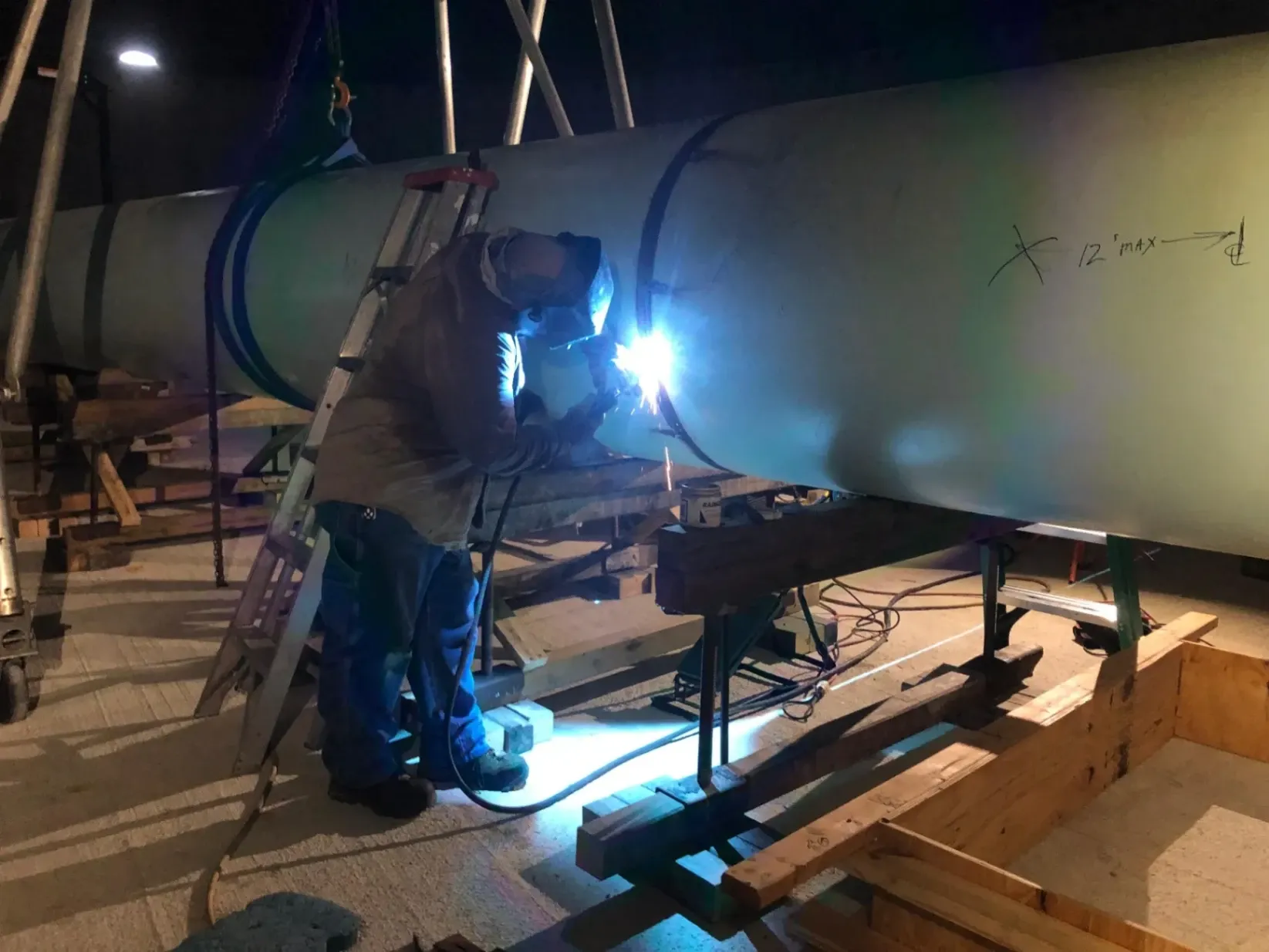 Abel Welding Services near Miramar, FL. AWS-certified industrial welder performing high-pressure pipe welding on a large water treatment plant line.
