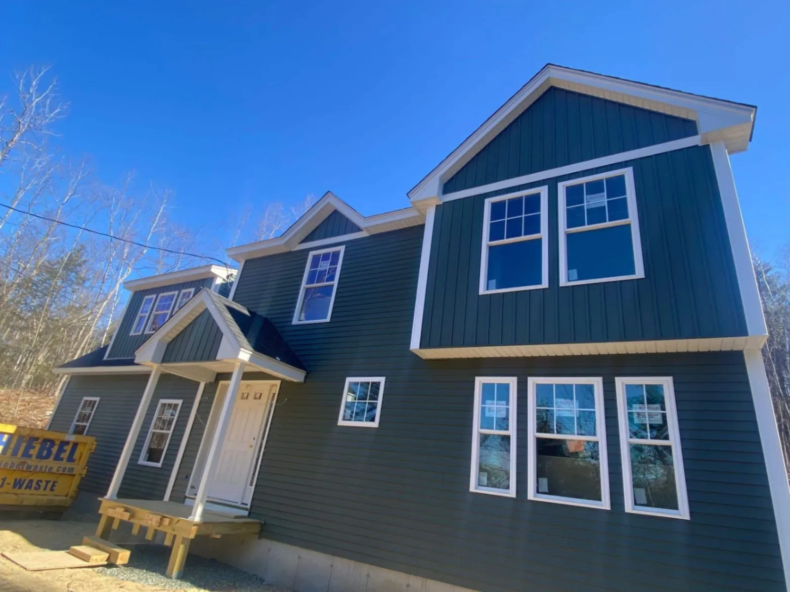High-performance board-and-batten siding installation in Westford, MA, completed by JM Exteriors Roofing Siding. Vivid colors and durable weather protection for Massachusetts homes.