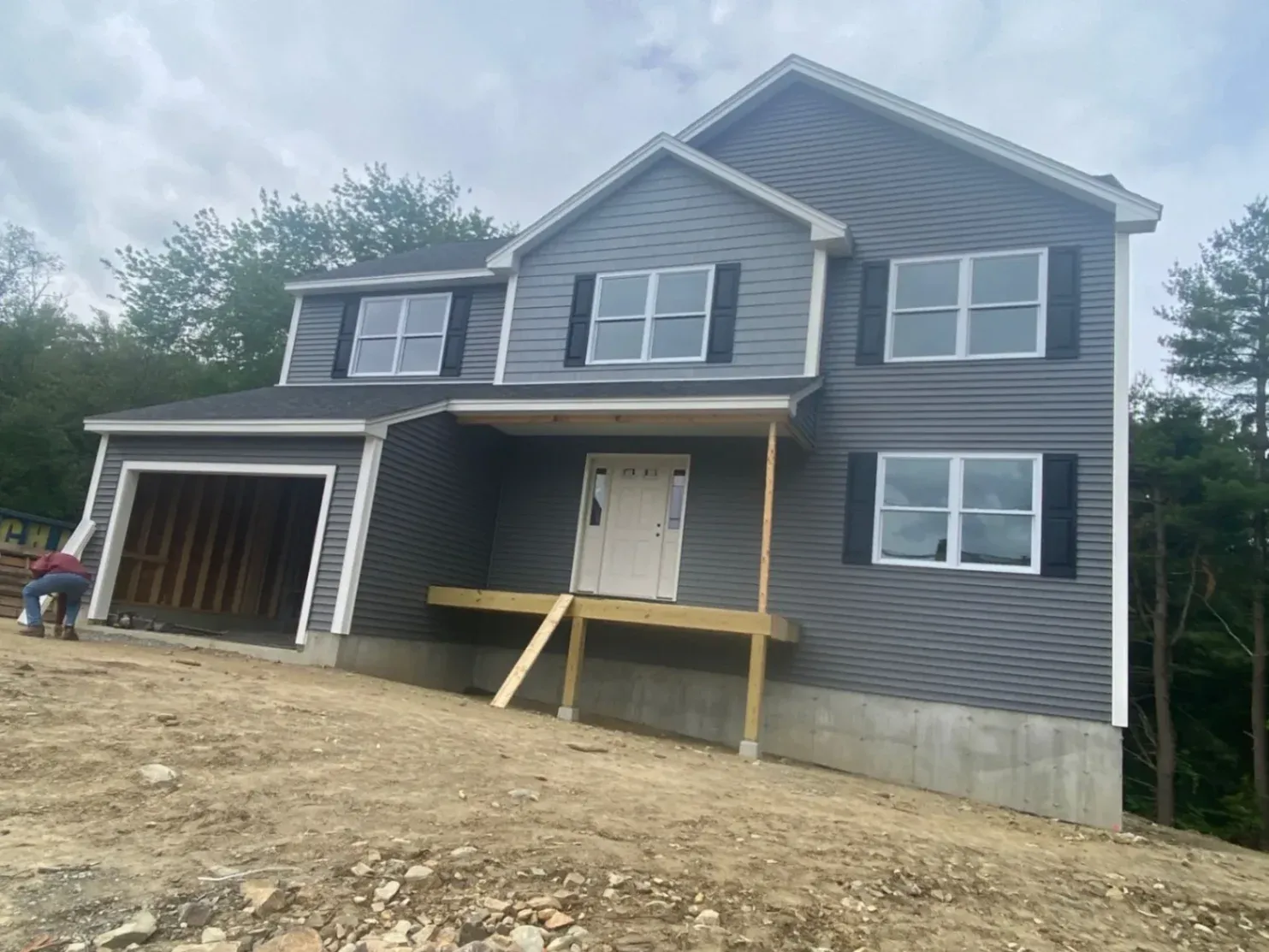 A completed premium siding installation in Chelmsford, MA, showcasing modern dark horizontal panels installed by JM Exteriors Roofing Siding, a professional siding contractor.