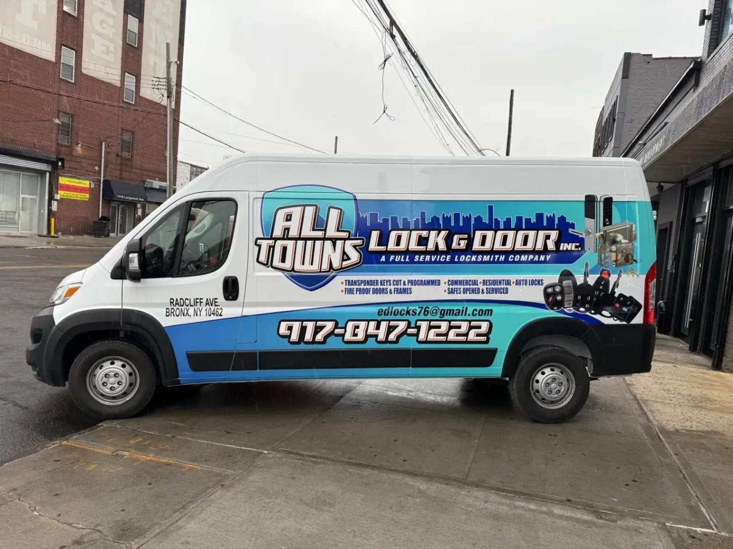 Custom commercial van vinyl wrap for All Towns Lock & Door by Print & Wrap Studio Corp near Staten Island, NY, featuring vibrant blue branding, locksmith graphics, and phone number.