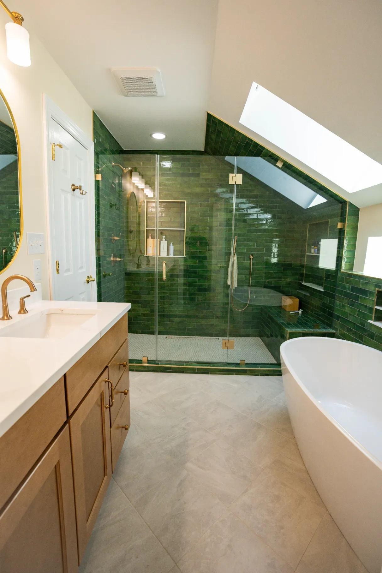 Custom white bathroom cabinet installation in Fairfax, featuring optimized drawer storage, elegant gold hardware, a premium marble countertop, and a matching gold-framed vanity mirror.