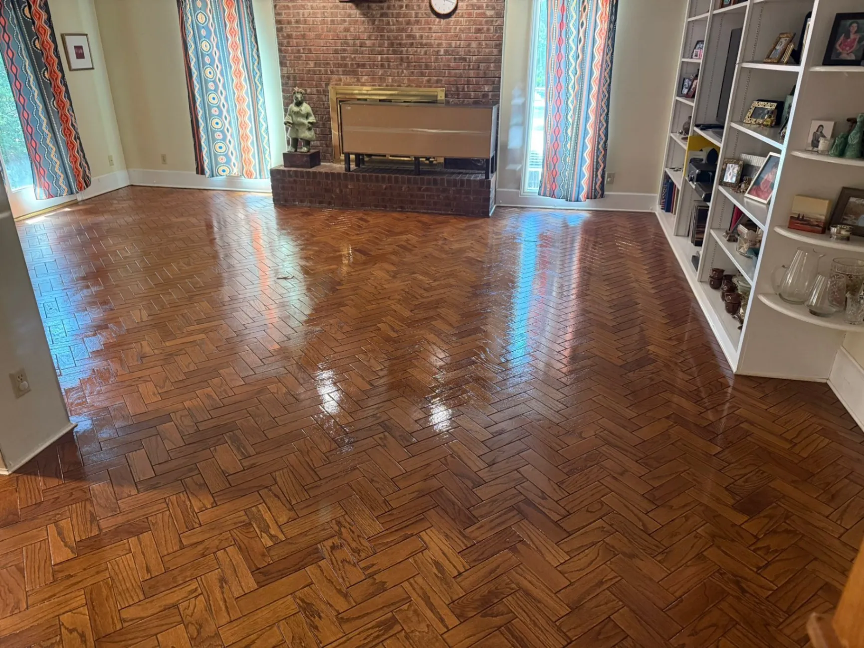 High-gloss parquet hardwood floor refinishing completed in an Apex, NC, home by DNH Hardwood Flooring.